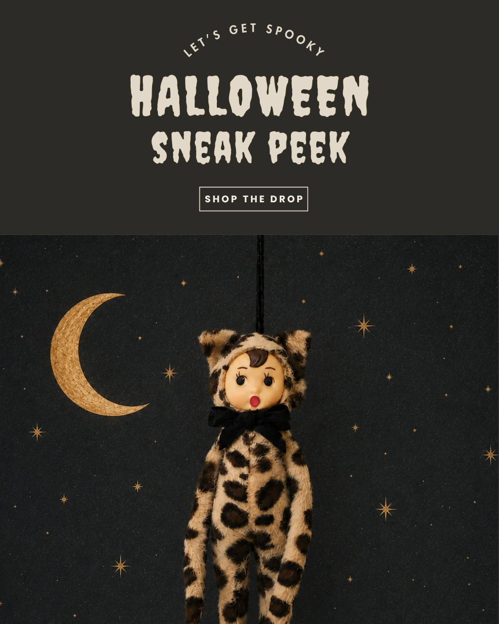 Promotional graphic for a Halloween sneak peek, featuring a plush cat doll hanging against a dark starry night sky with a crescent moon. Text at the top reads 'LET'S GET SPOOKY HALLOWEEN SNEAK PEEK' and 'SHOP THE DROP'.