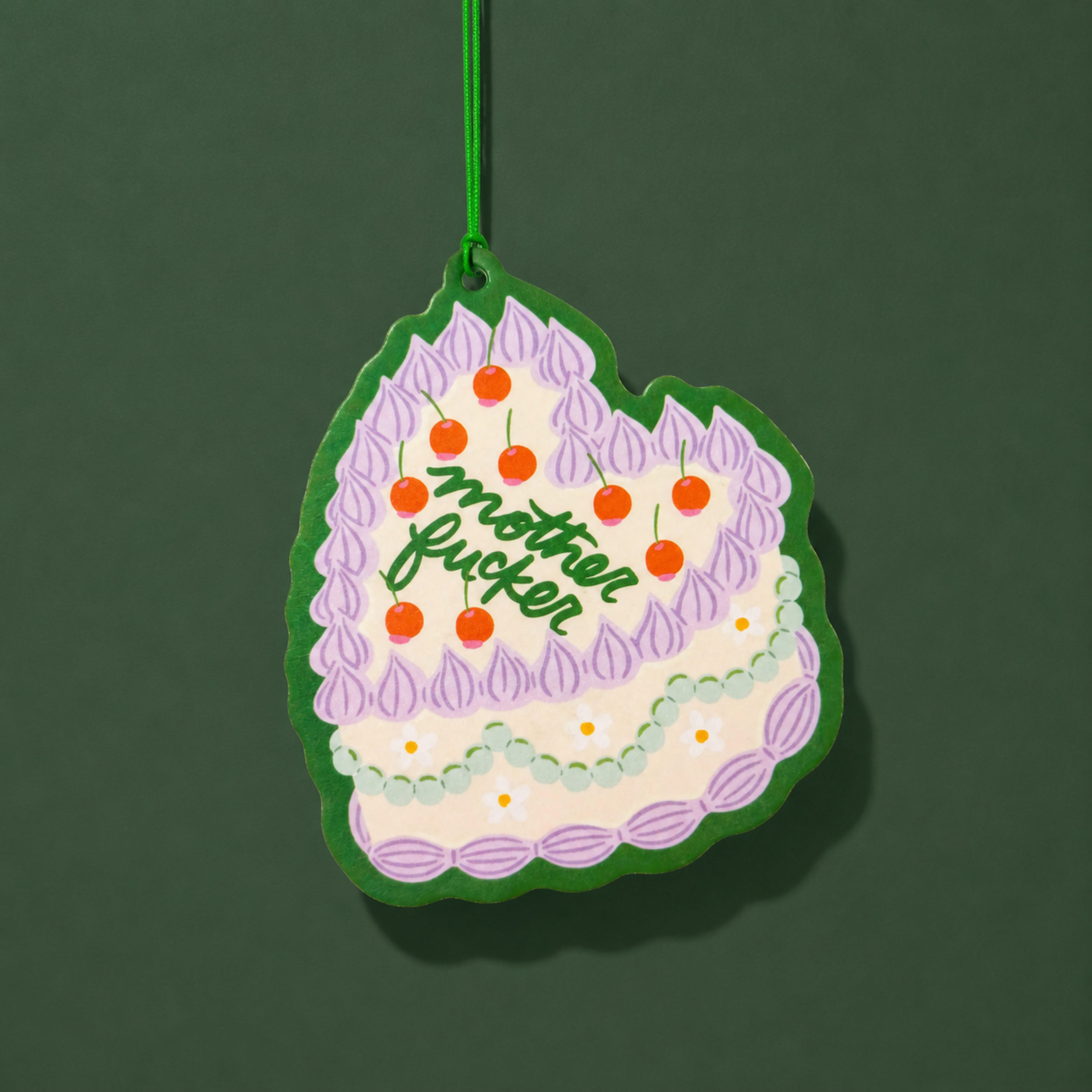 a vintage inspired cake shaped air freshener with "mother fucker" written on the top of the cake. 
