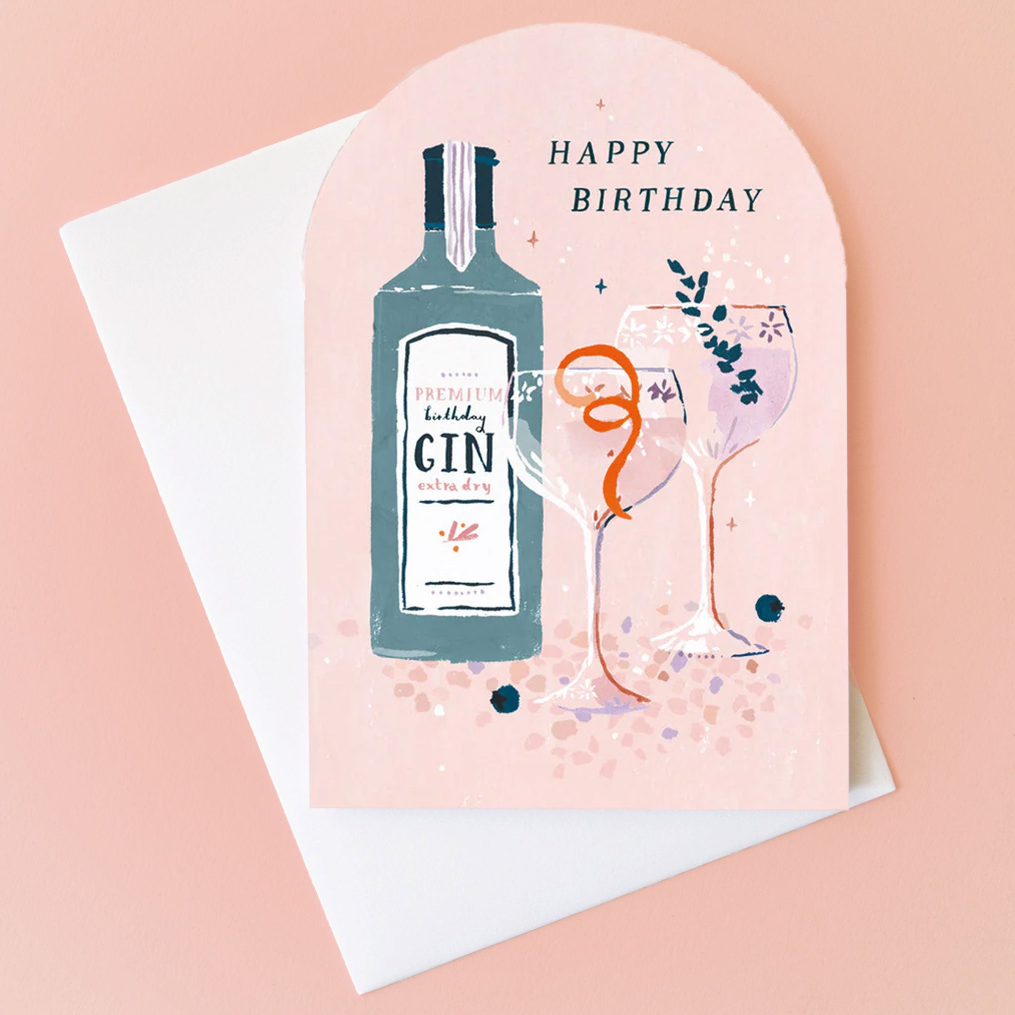 On a peachy background is an arched card with an illustration of cocktail glasses and a bottle of gin and text that reads, "Happy Birthday". 