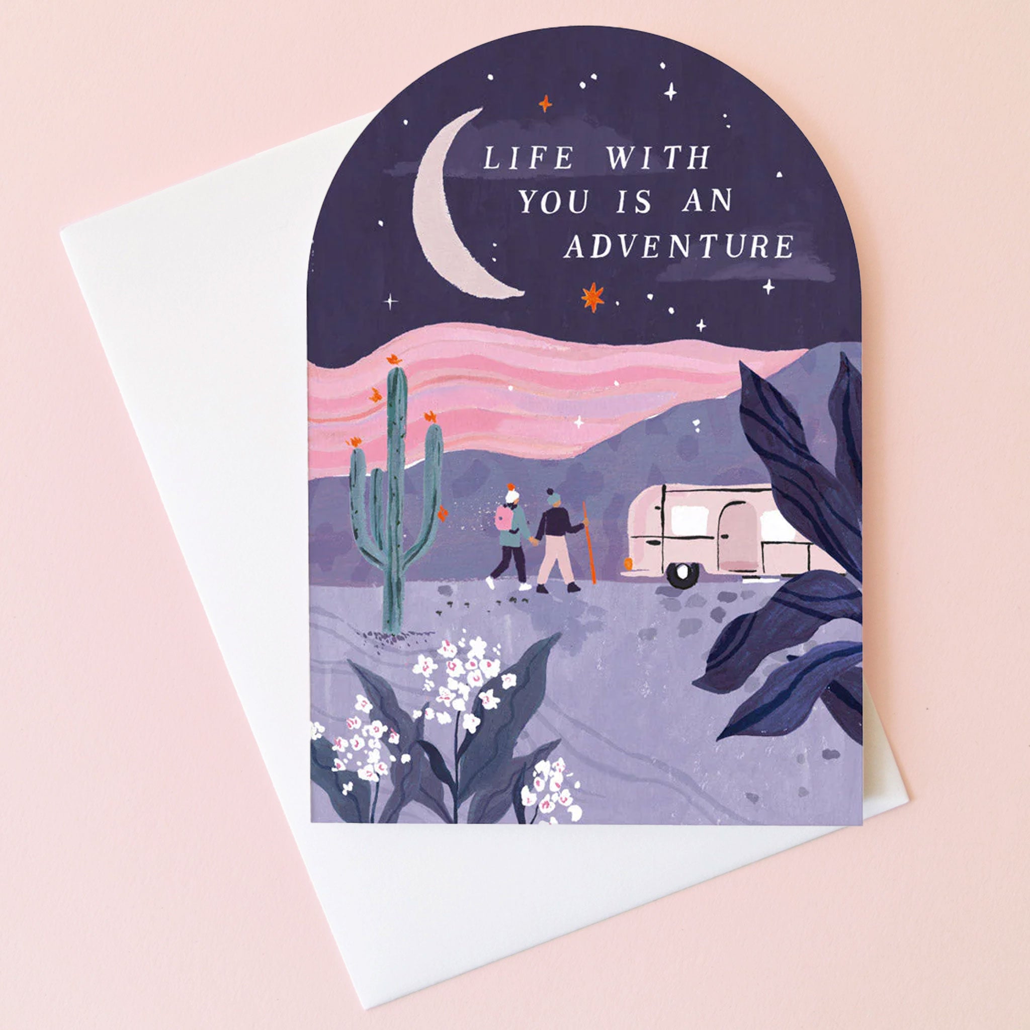 On a tan background is an arched card with a desert scape and text at the top that reads, &quot;Life With You Is An Adventure&quot;. 