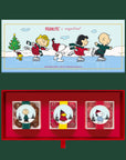 A three piece box of assorted candies with the characters of Peanuts on the boxes. 
