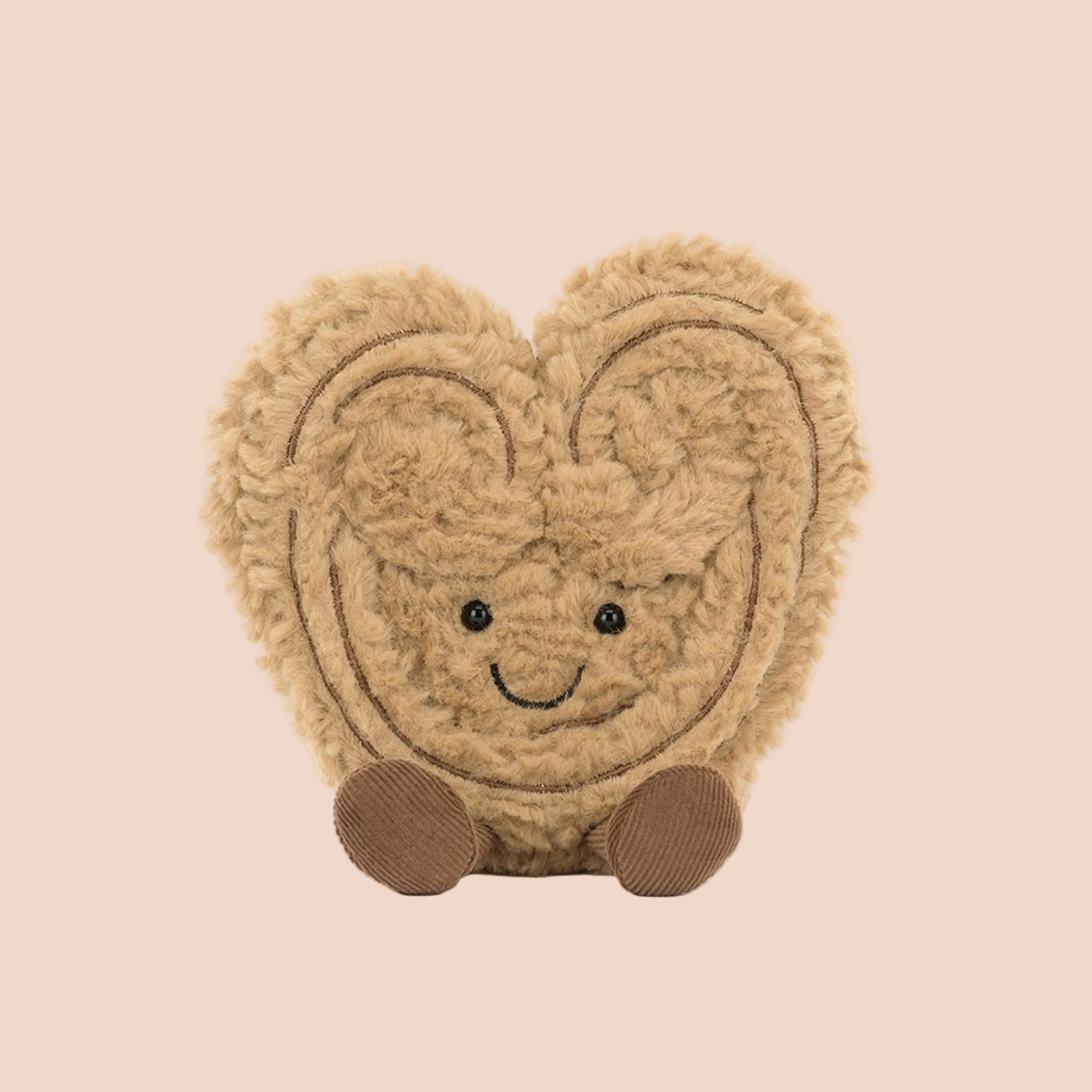 A brown stuffed toy with a smiling face and brown legs and feet. 