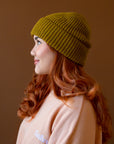 An olive green knit beanie. 