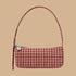 A tan and dark pinkish red patterned shoulder bag.