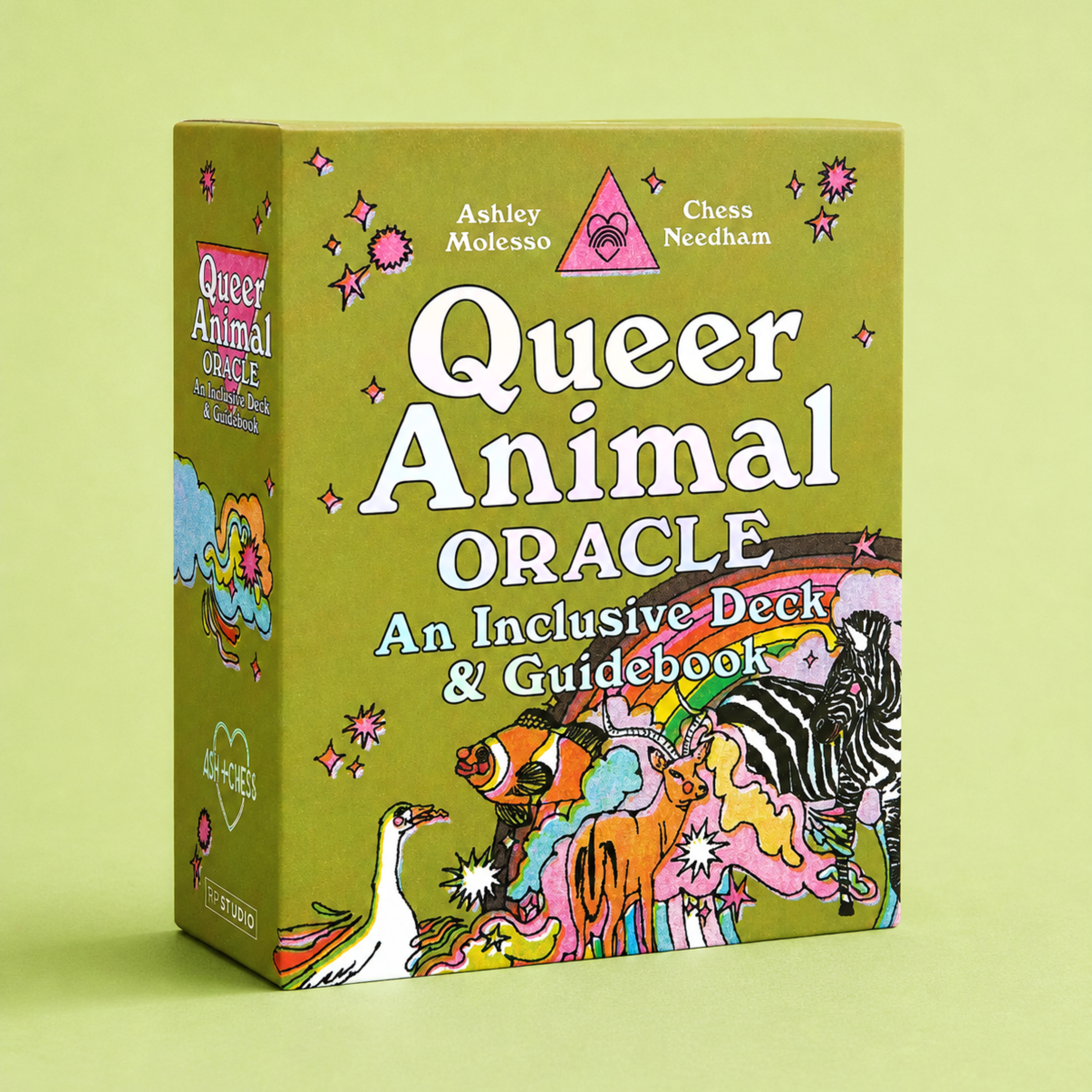 Queer Animal Oracle deck and guidebook box shown at a slight angle on a solid light green background. The box is olive green with white text and colorful whimsical animal illustrations including a zebra, ostrich, giraffe, and a rainbow.