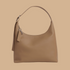 A tan recycled leather shoulder handbag.