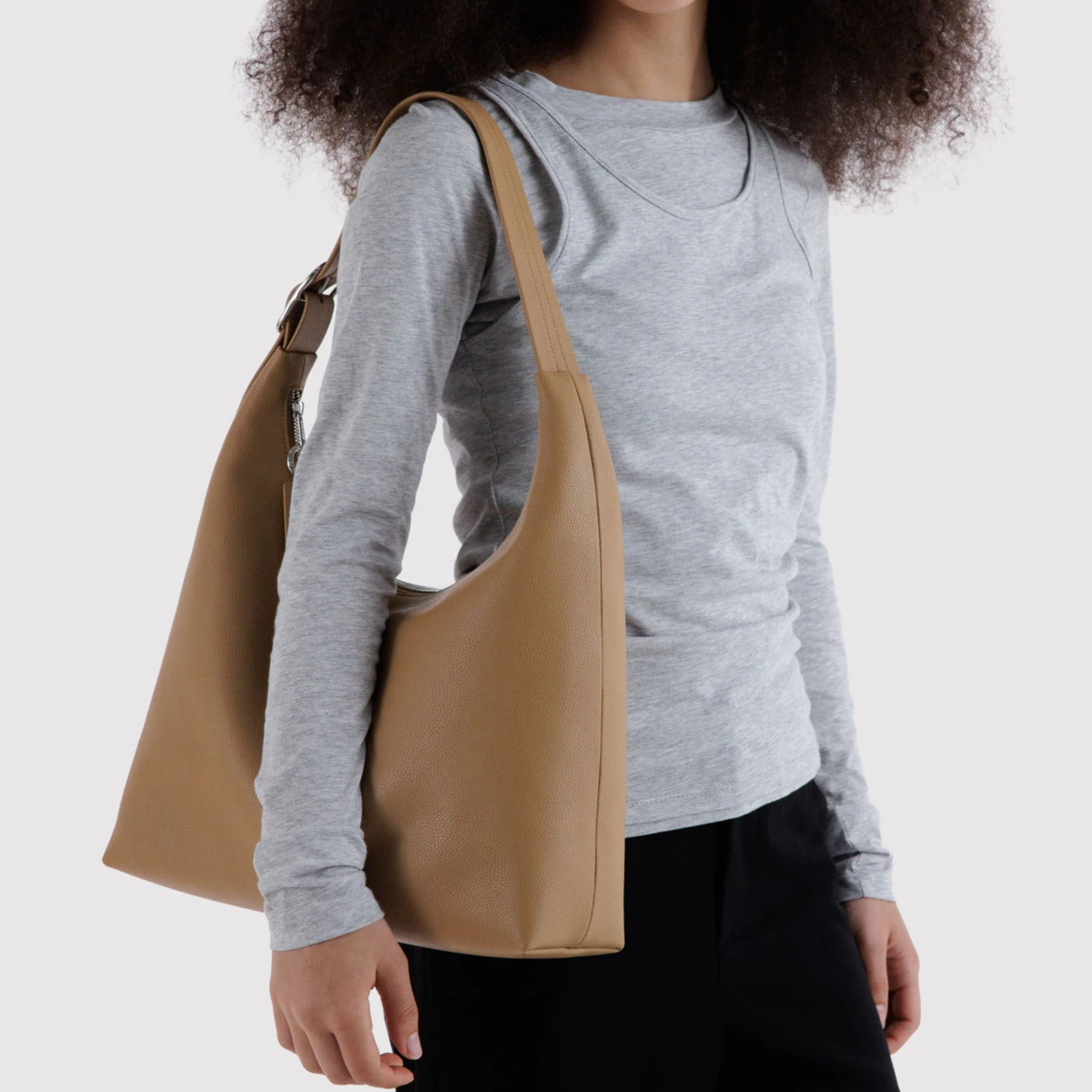 A tan recycled leather shoulder handbag.