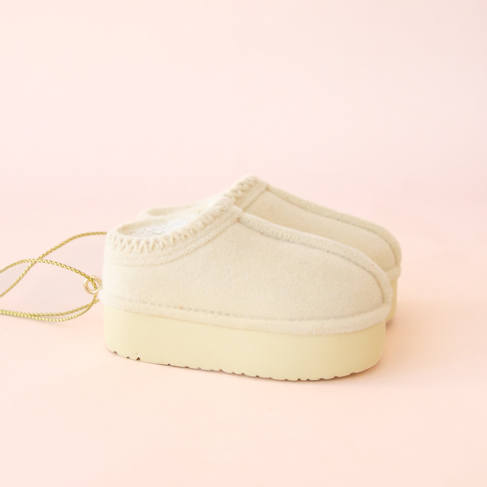 A cream pair of UGG slippers inspired ornament.