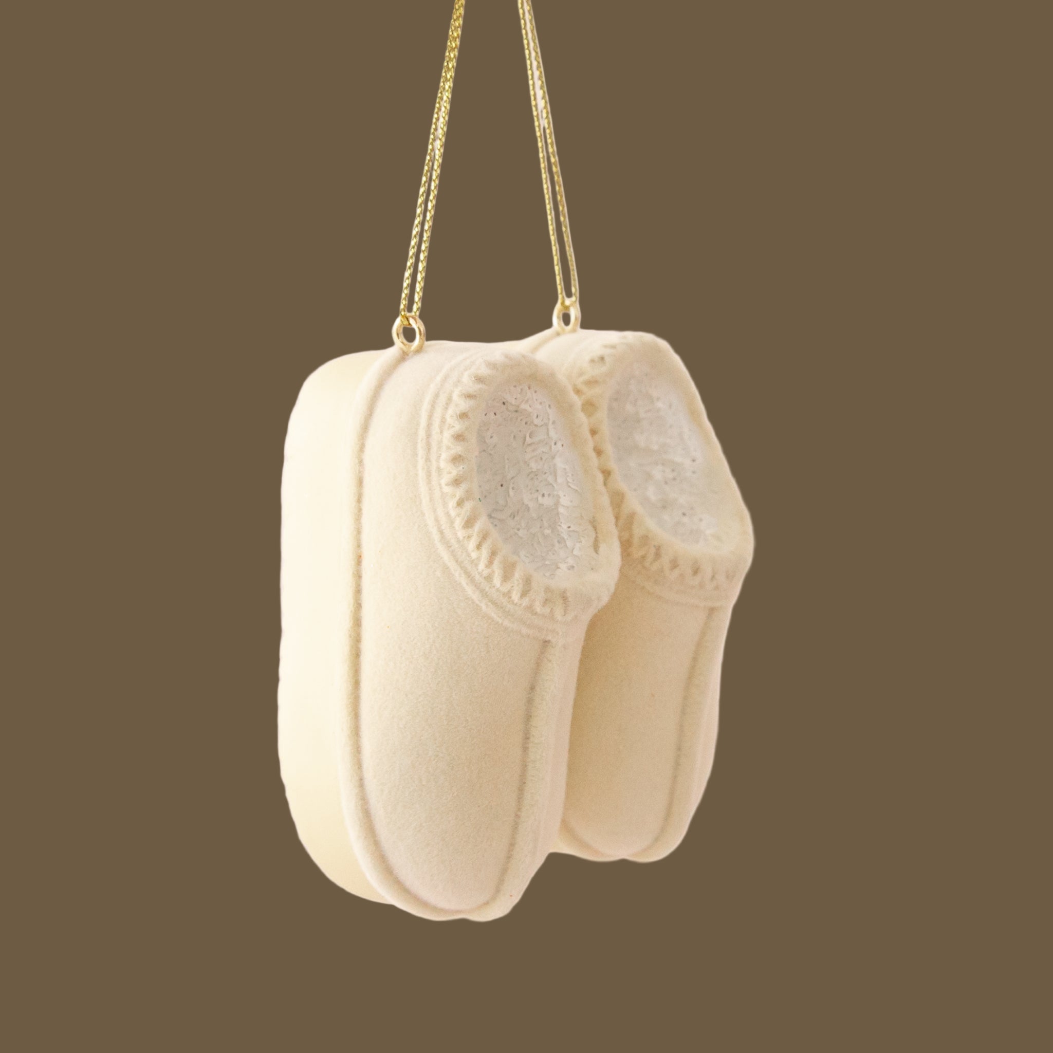 A cream pair of UGG slippers inspired ornament.