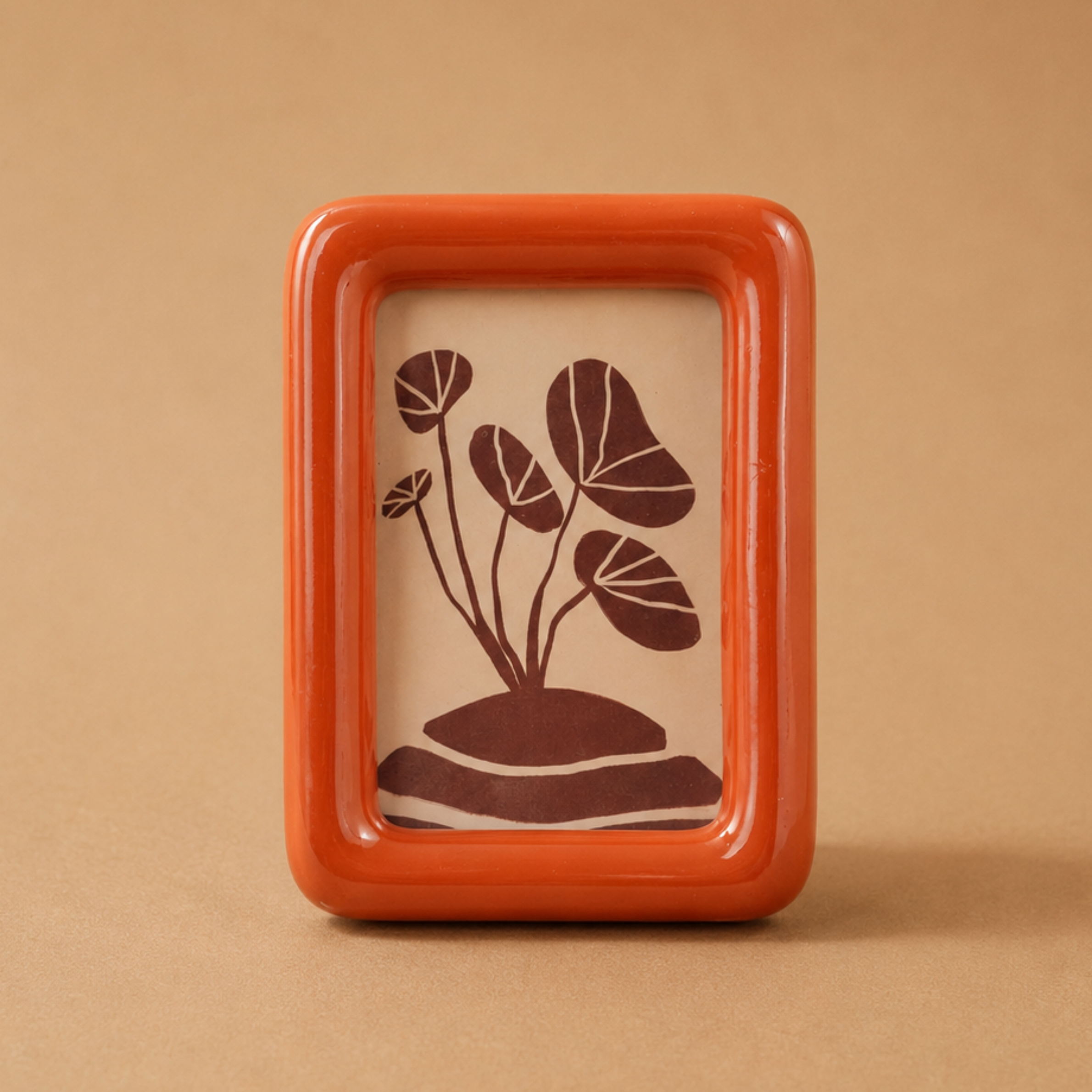 an orange resin picture frame. 