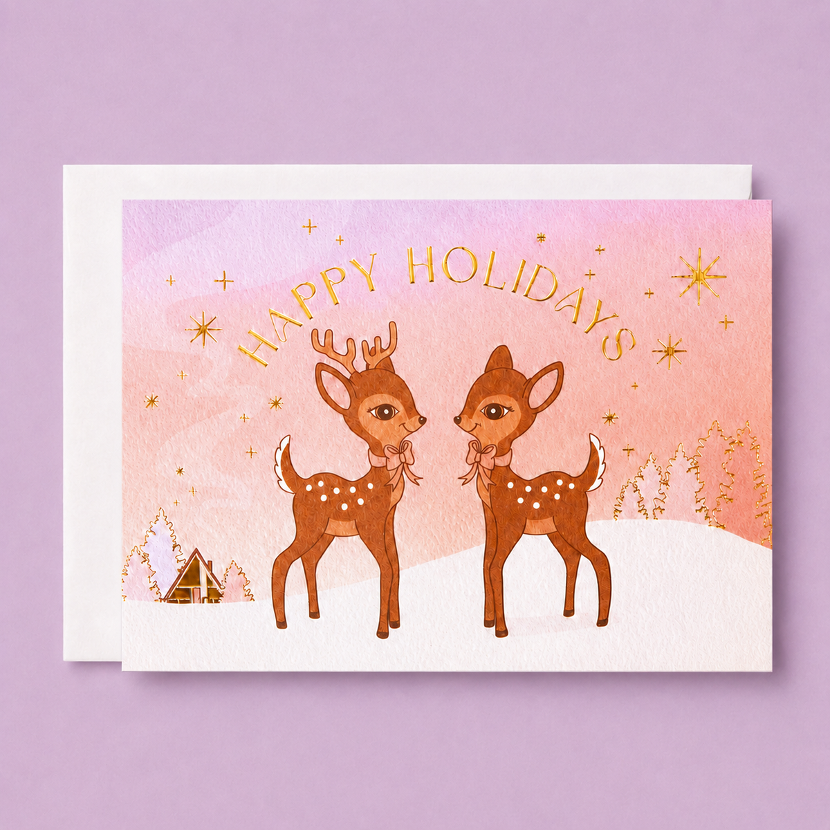On a purple background is a greeting card with two brown retro deer graphics along with gold foiled details and text that read, "Happy Holidays".