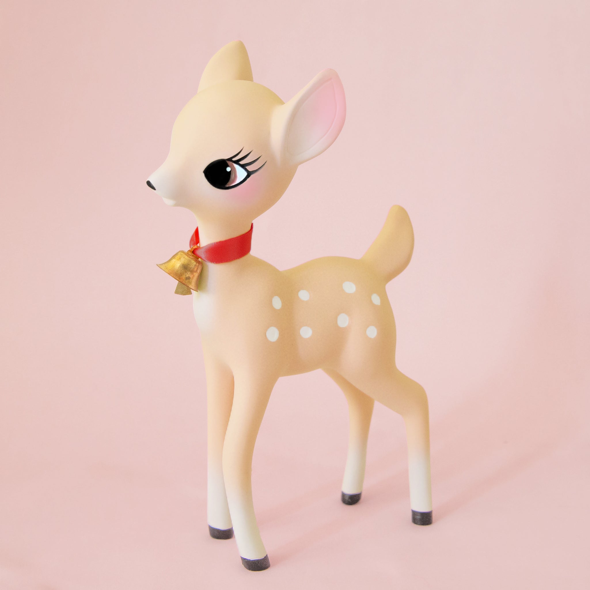 A light tan retro deer figurine with a red collar and bell. 
