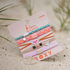 Set of colorful hair accessories on a sandy surface with 'K'lani' branding.