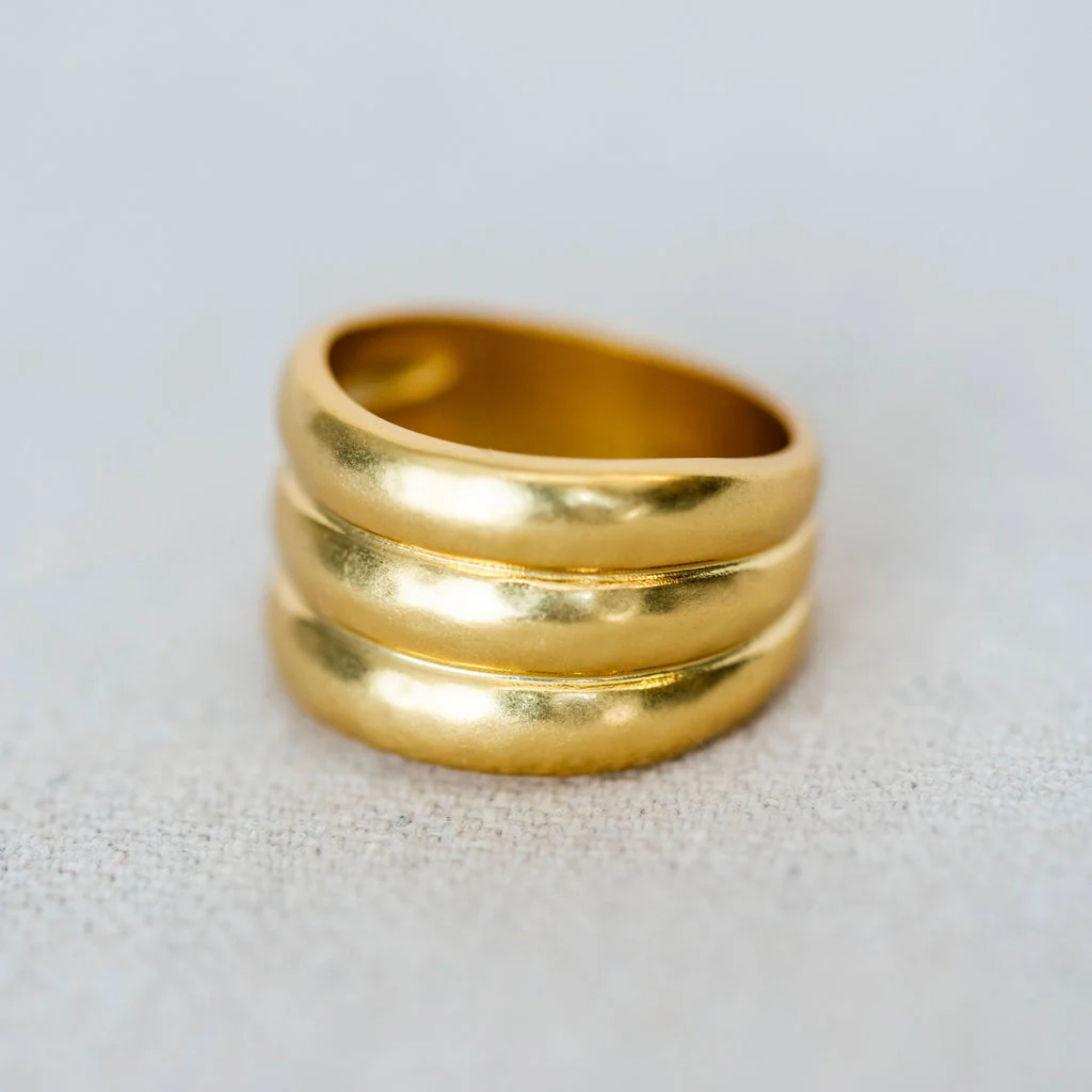 A wide sculptural band with soft curves and an organic finish
