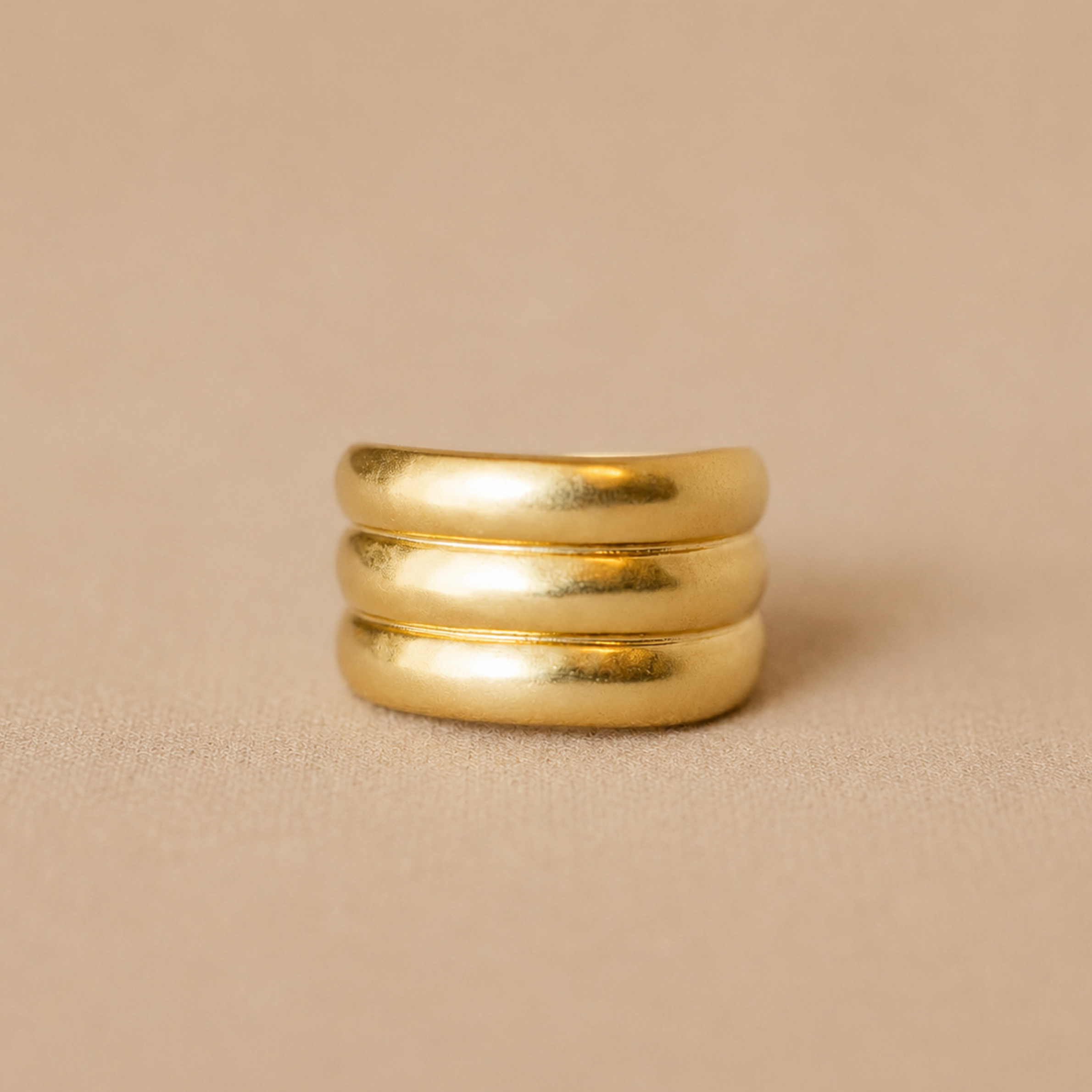 A wide sculptural band with soft curves and an organic finish