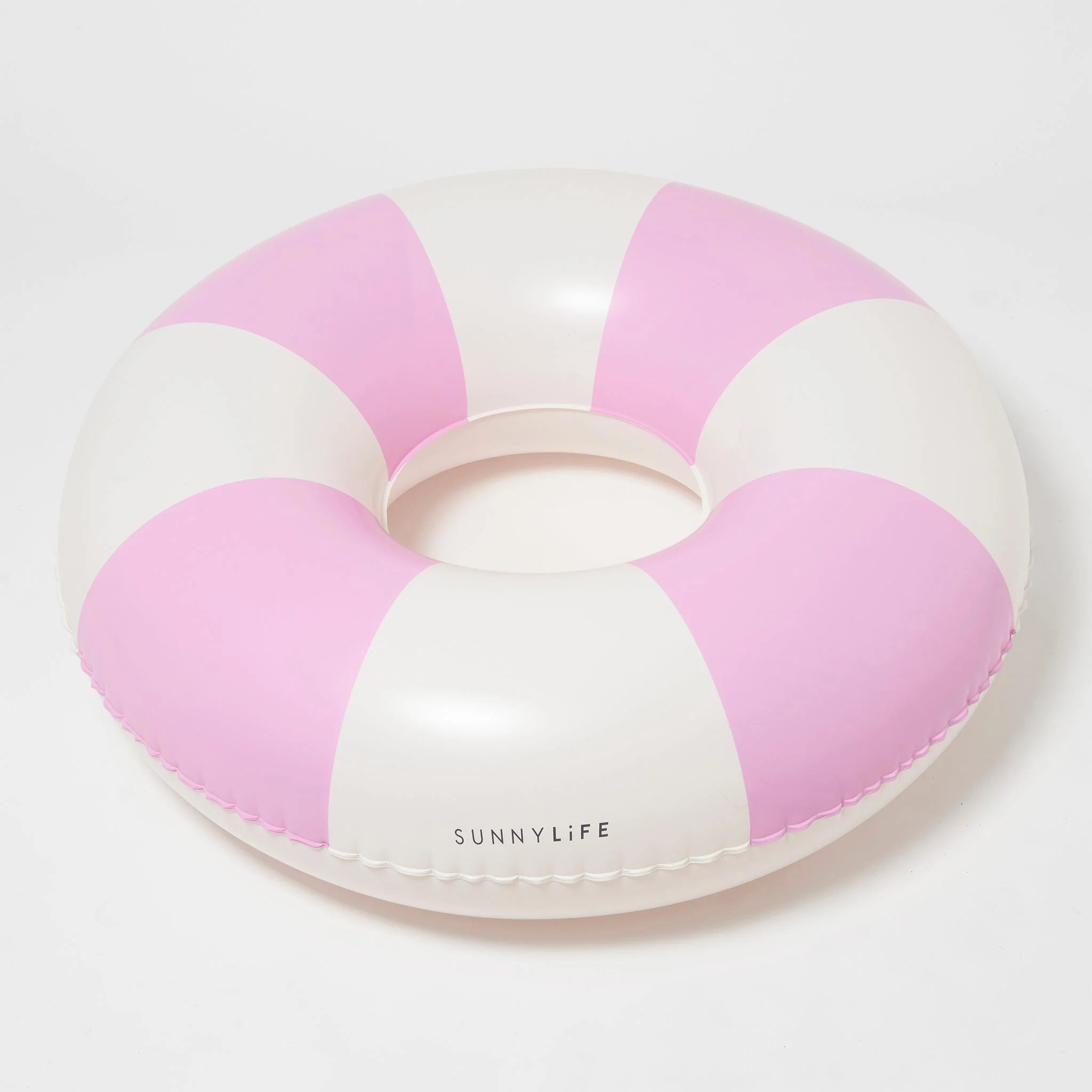 A pink and white pool ring float. 