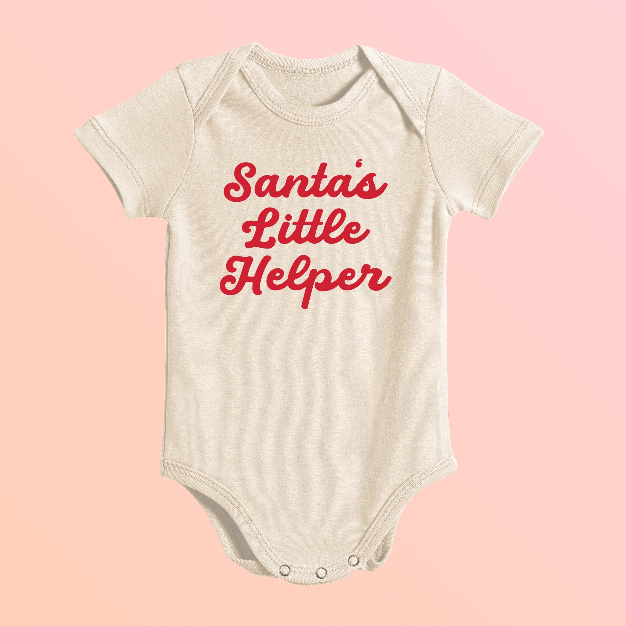 A cream colored onesie with red text that reads, "Santa's Little Helper". 