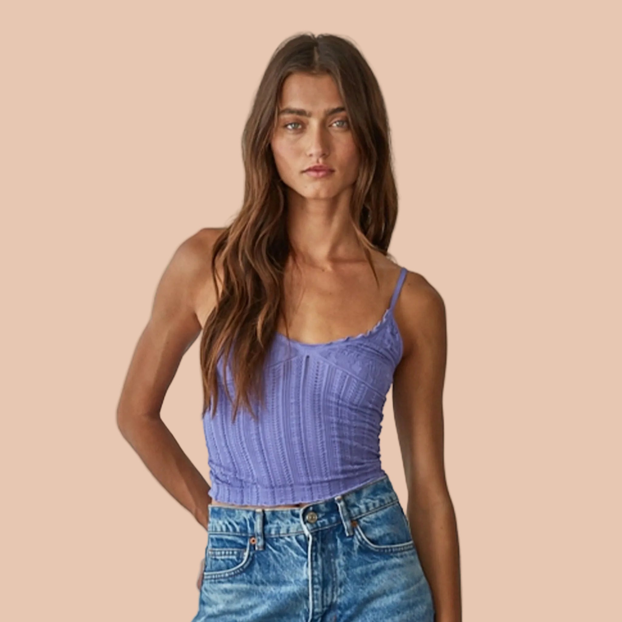 A model wearing a purple tank top with spaghetti straps. 