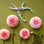 Minty blue colored pruning shears above beautiful pink dahlias.