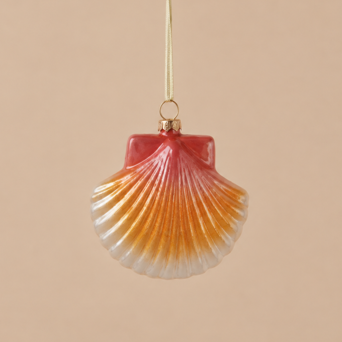 a pink, orange and white shell shaped ornament. 