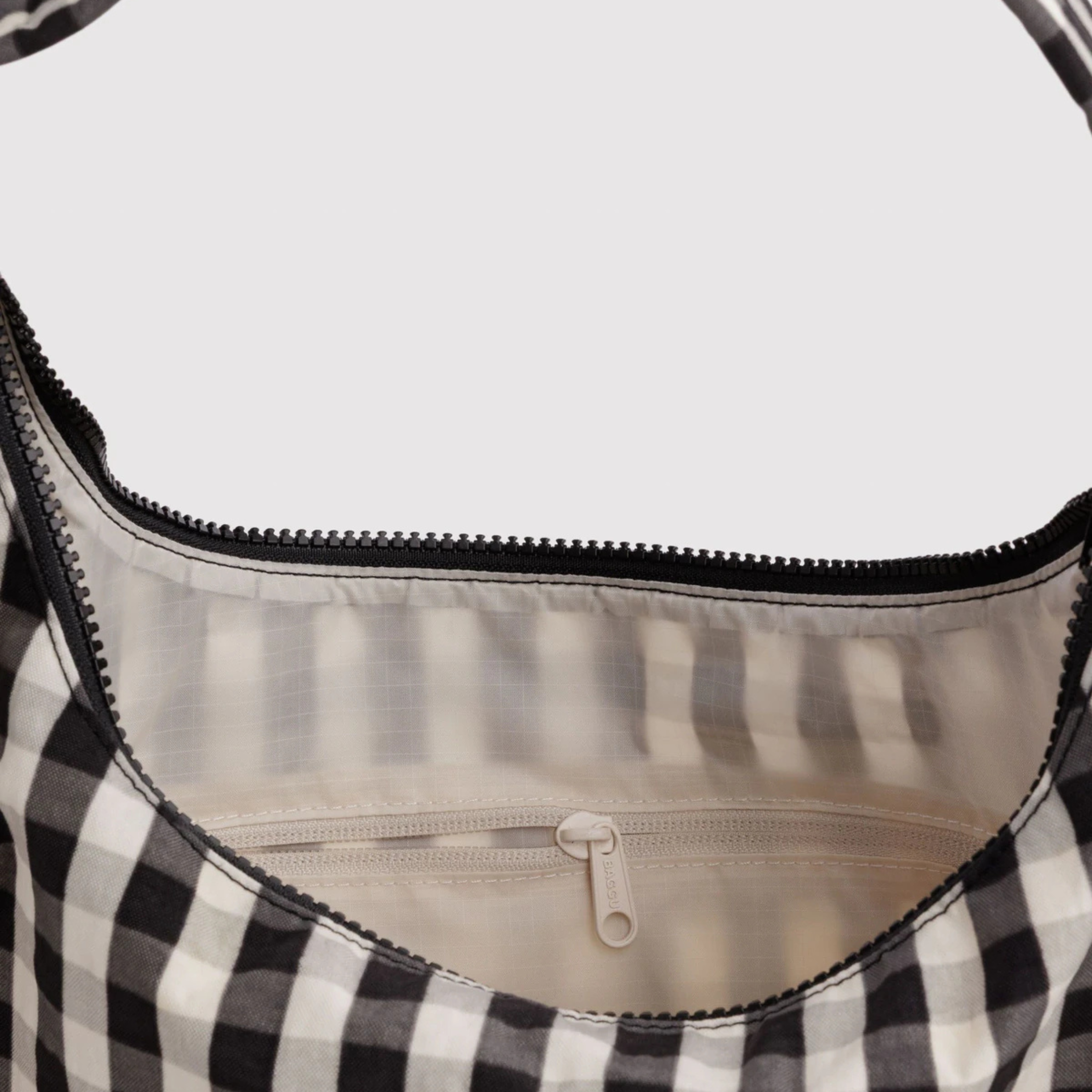 A black and cream gingham shoulder bag.