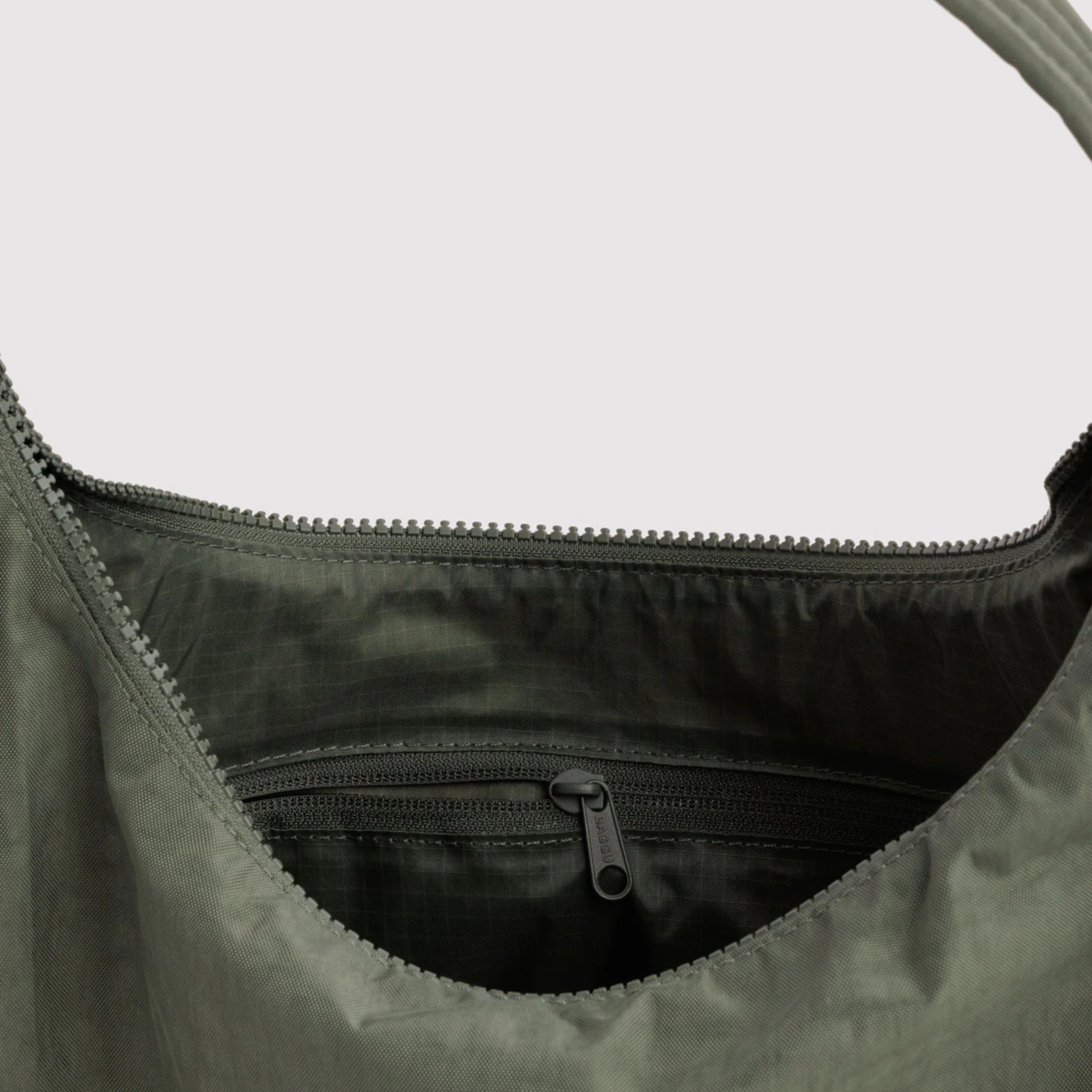 A green nylon shoulder bag.