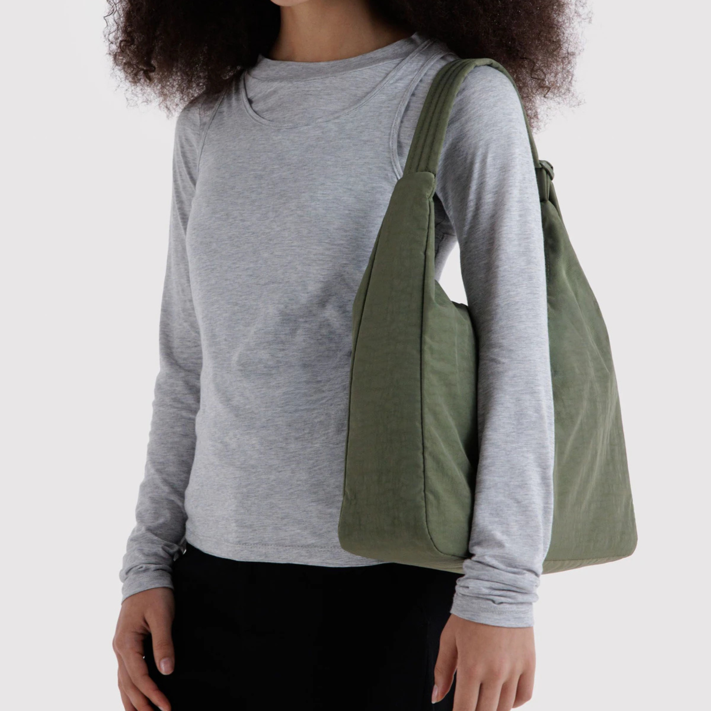 A green nylon shoulder bag.