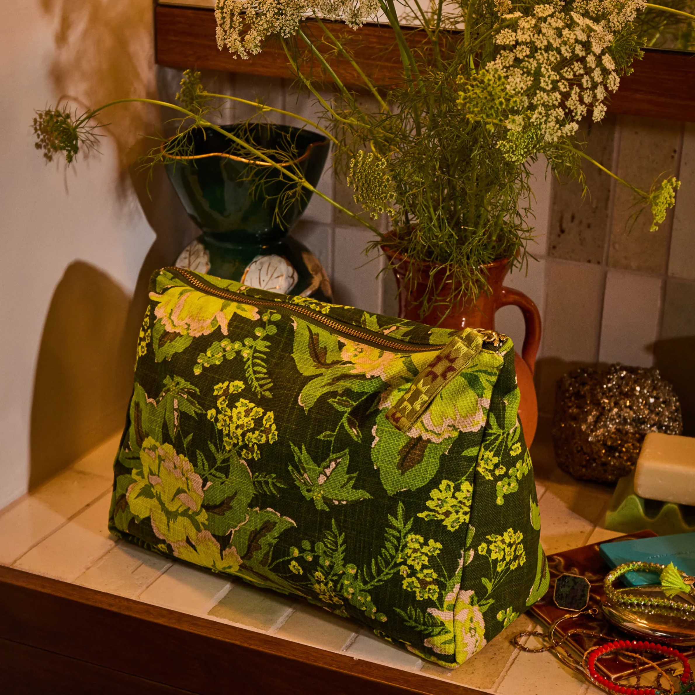 a green floral print cosmetic bag. 