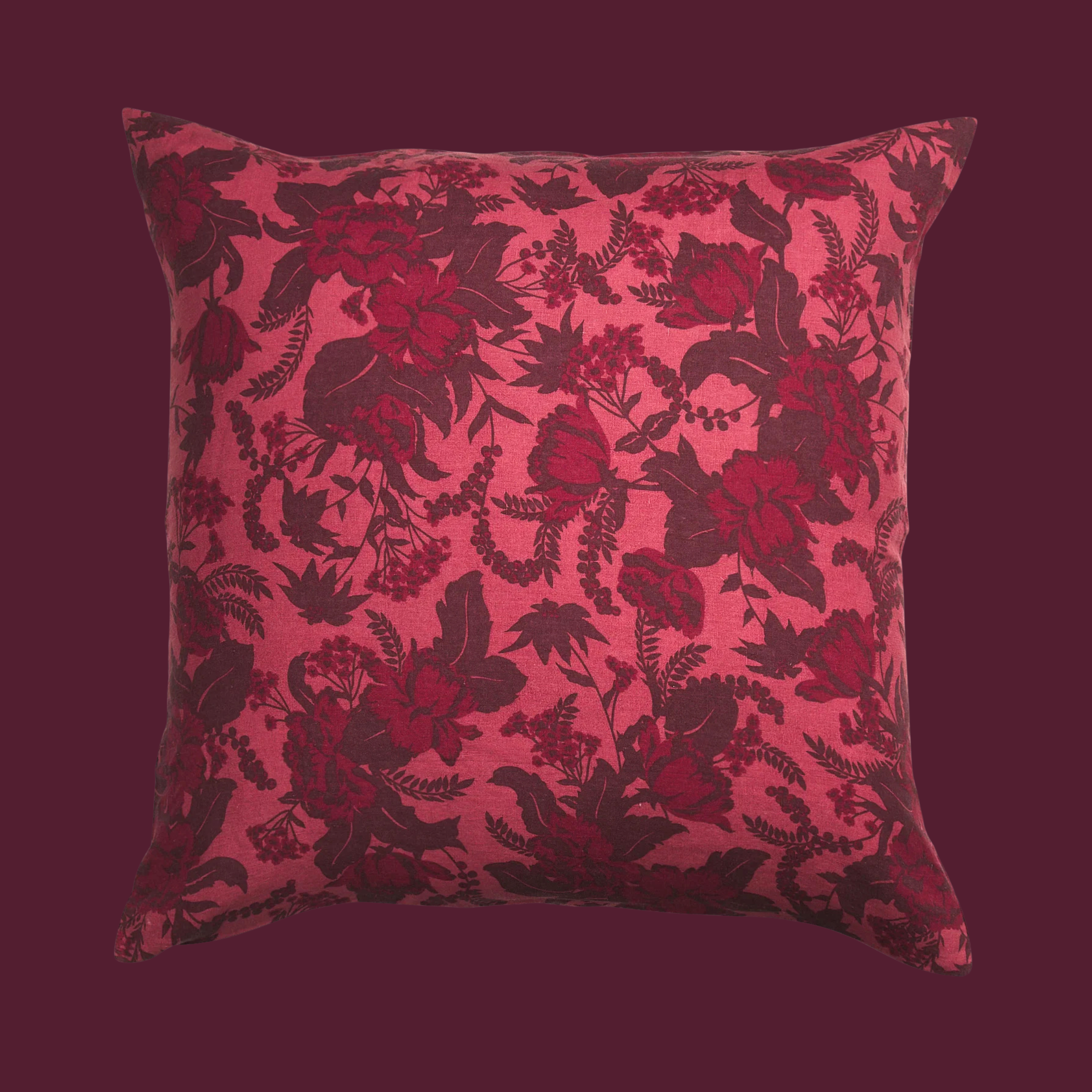 a burgundy and pink floral printed pillow