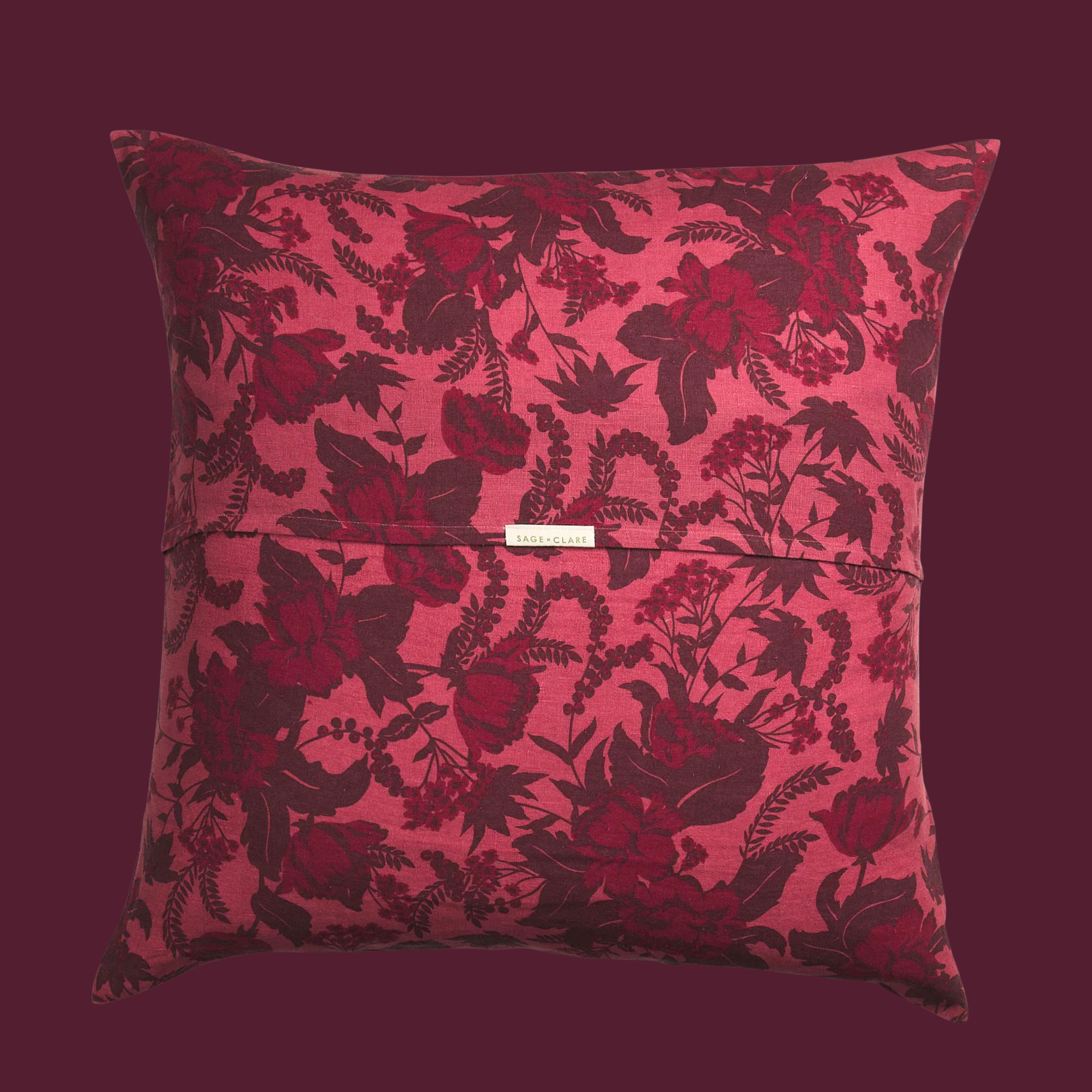 a burgundy and pink floral printed pillow