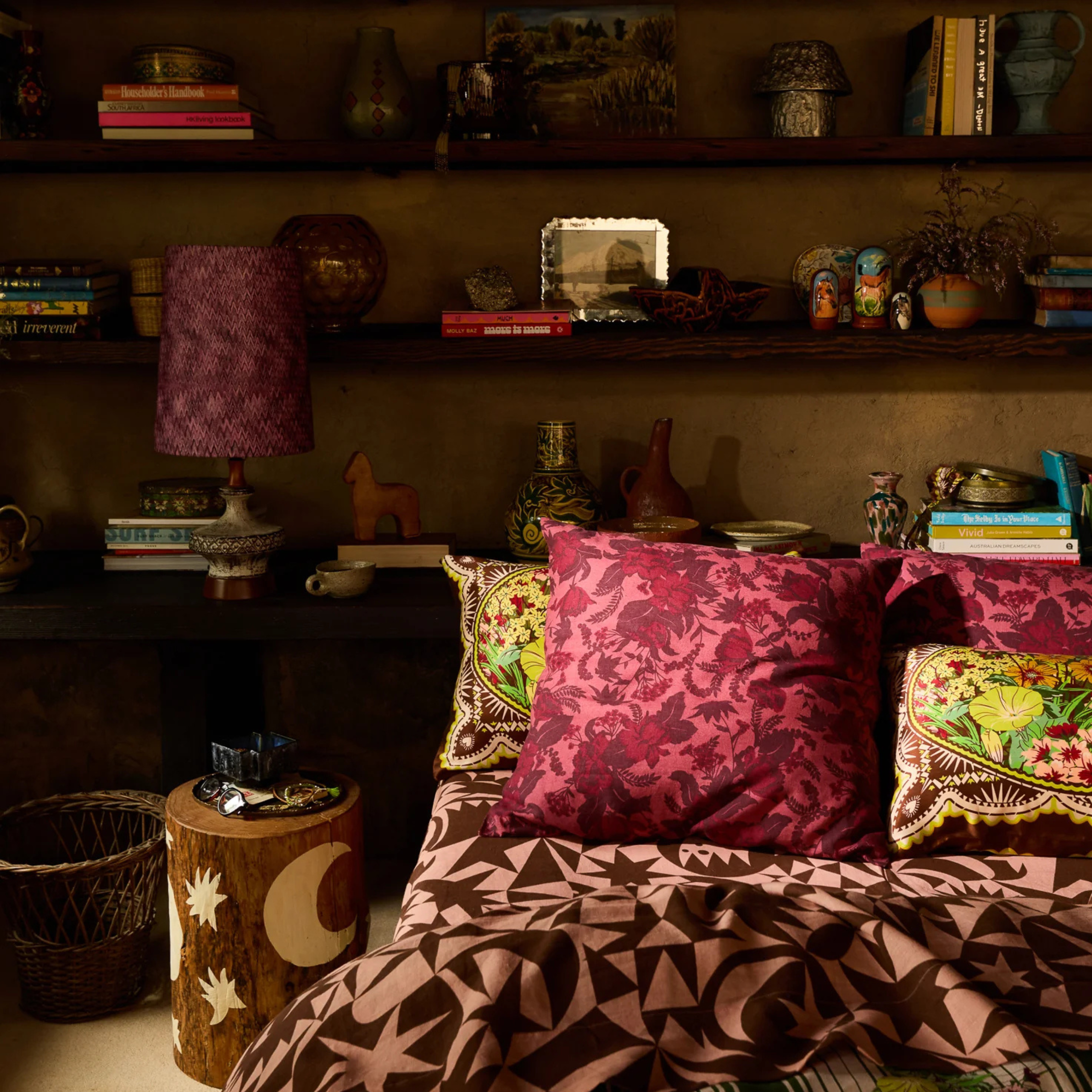 a burgundy and pink floral printed pillow