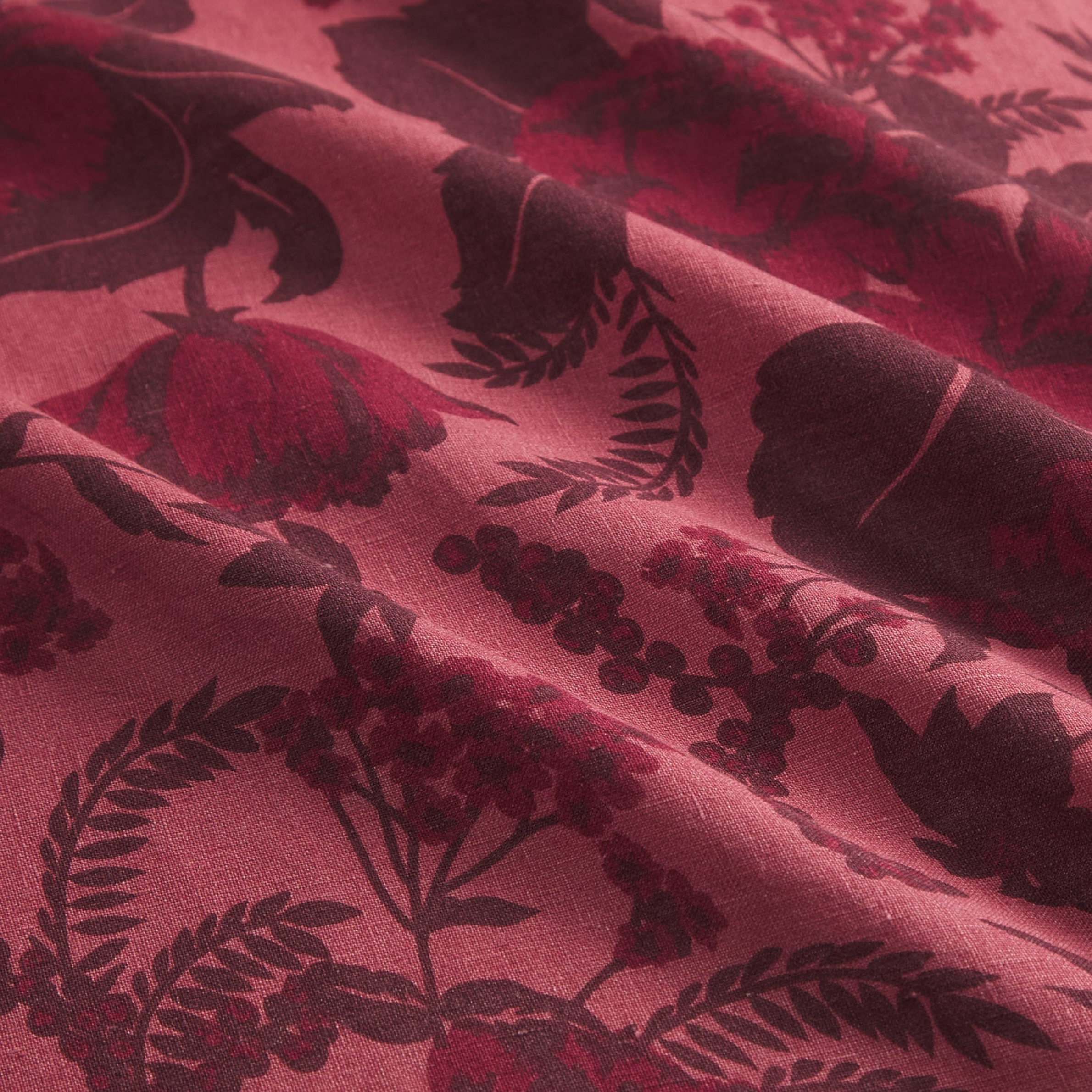 a burgundy and pink floral printed pillow