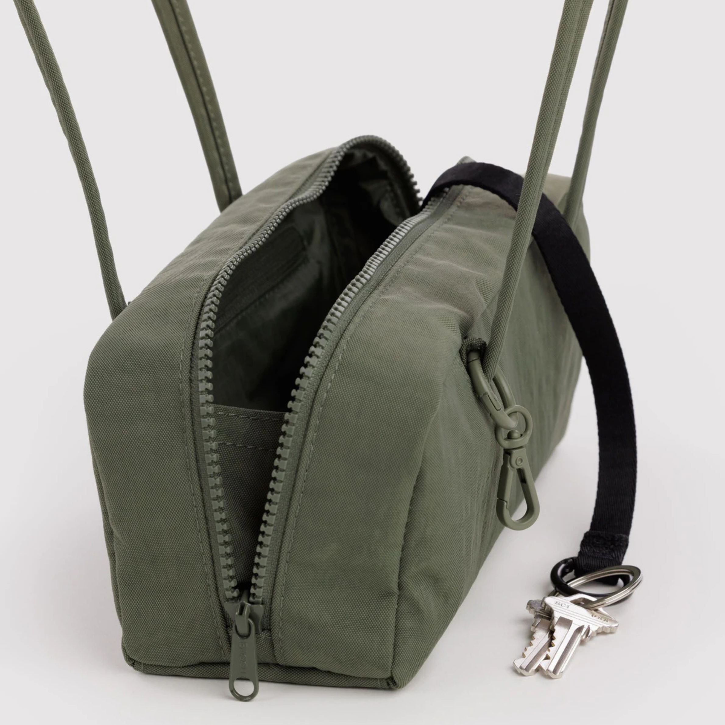 A green nylon shoulder bag.