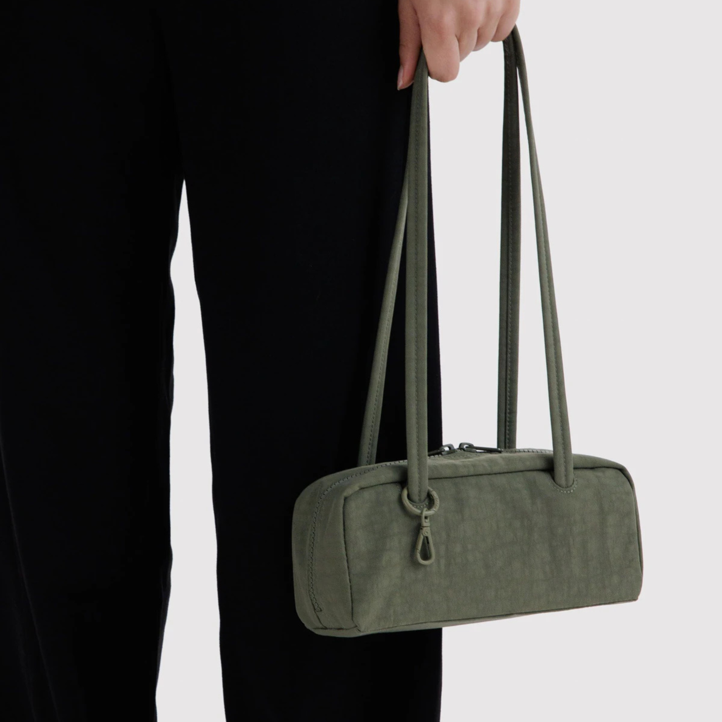 A green nylon shoulder bag.