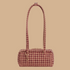 A rust and tan patterned shoulder bag.