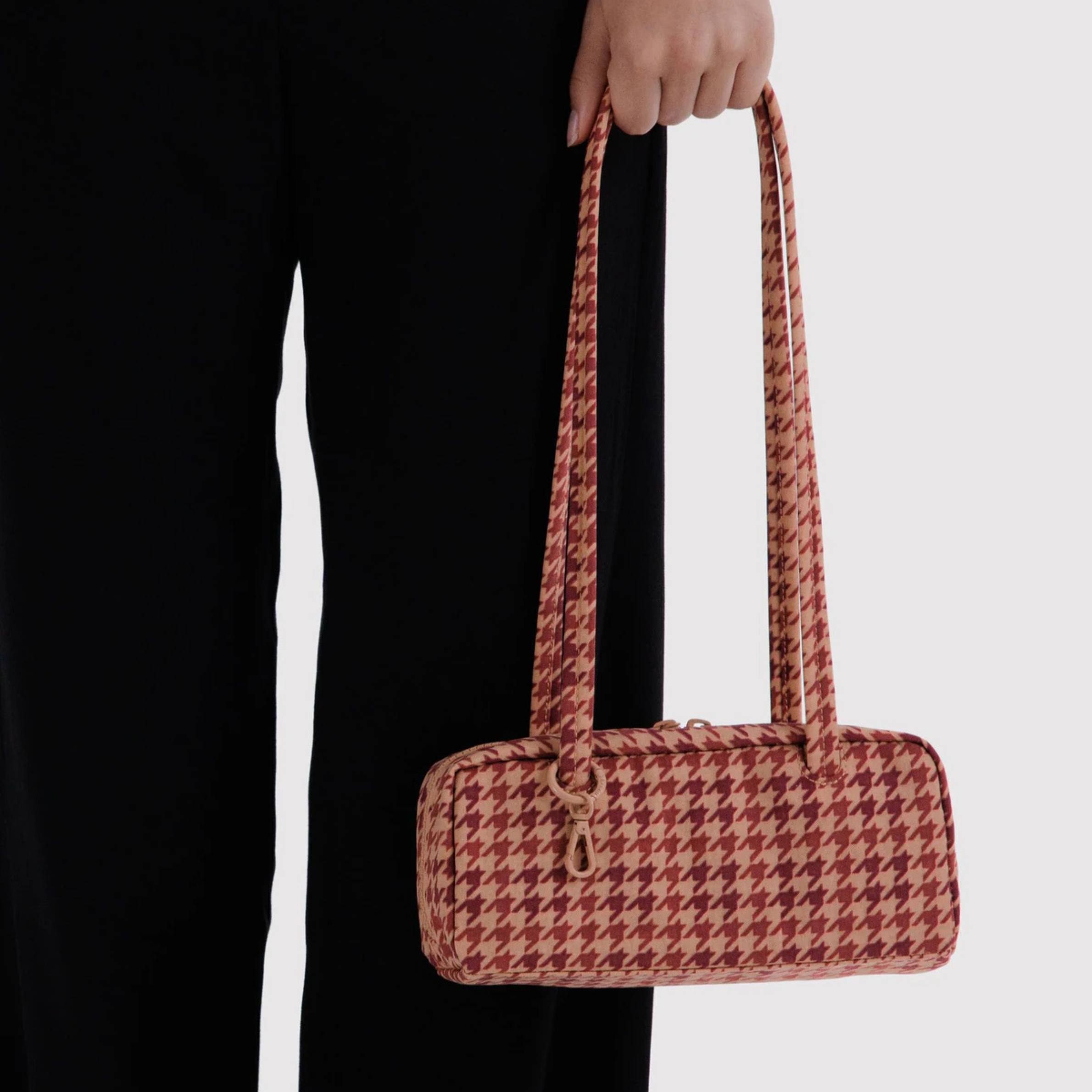 A rust and tan patterned shoulder bag.