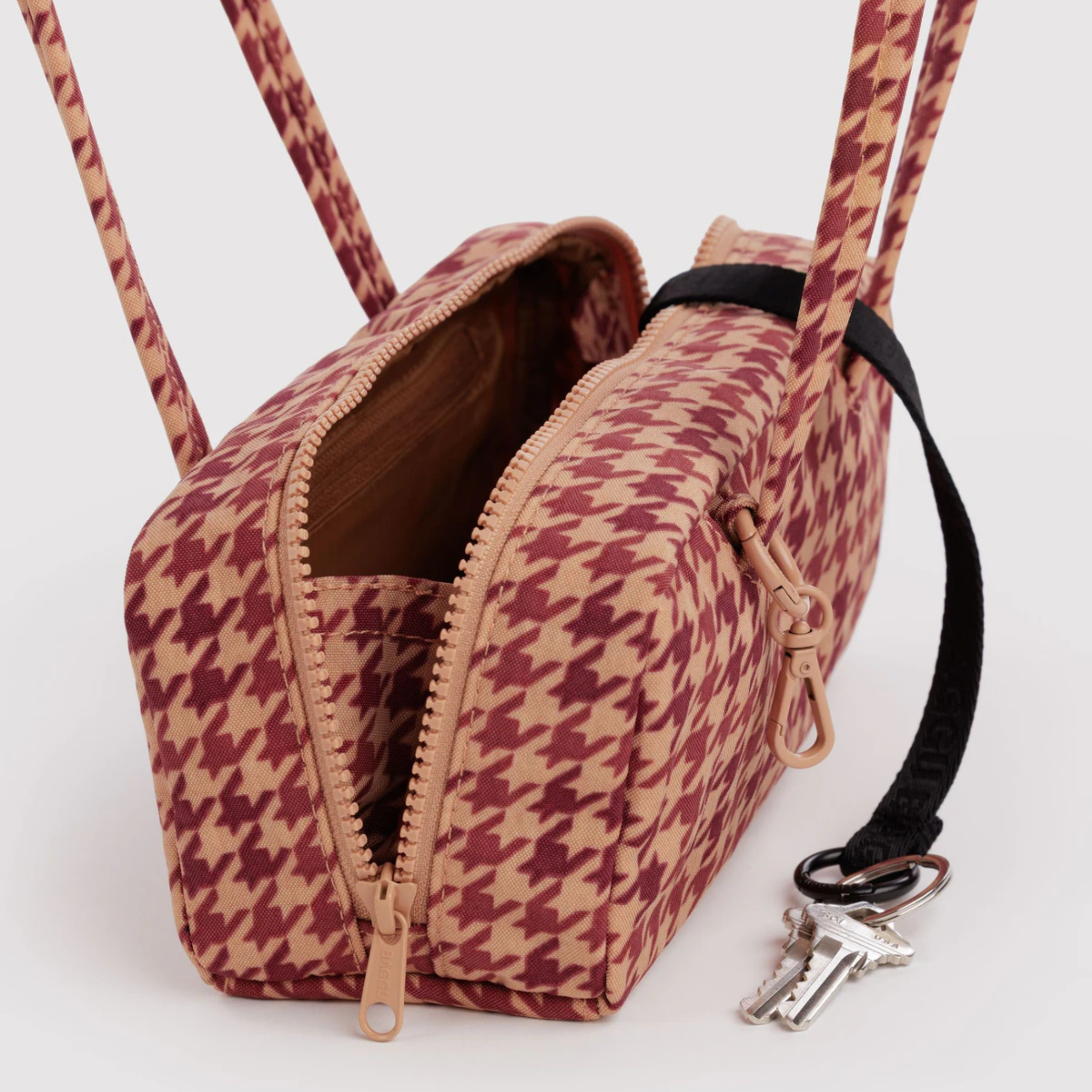 A rust and tan patterned shoulder bag.