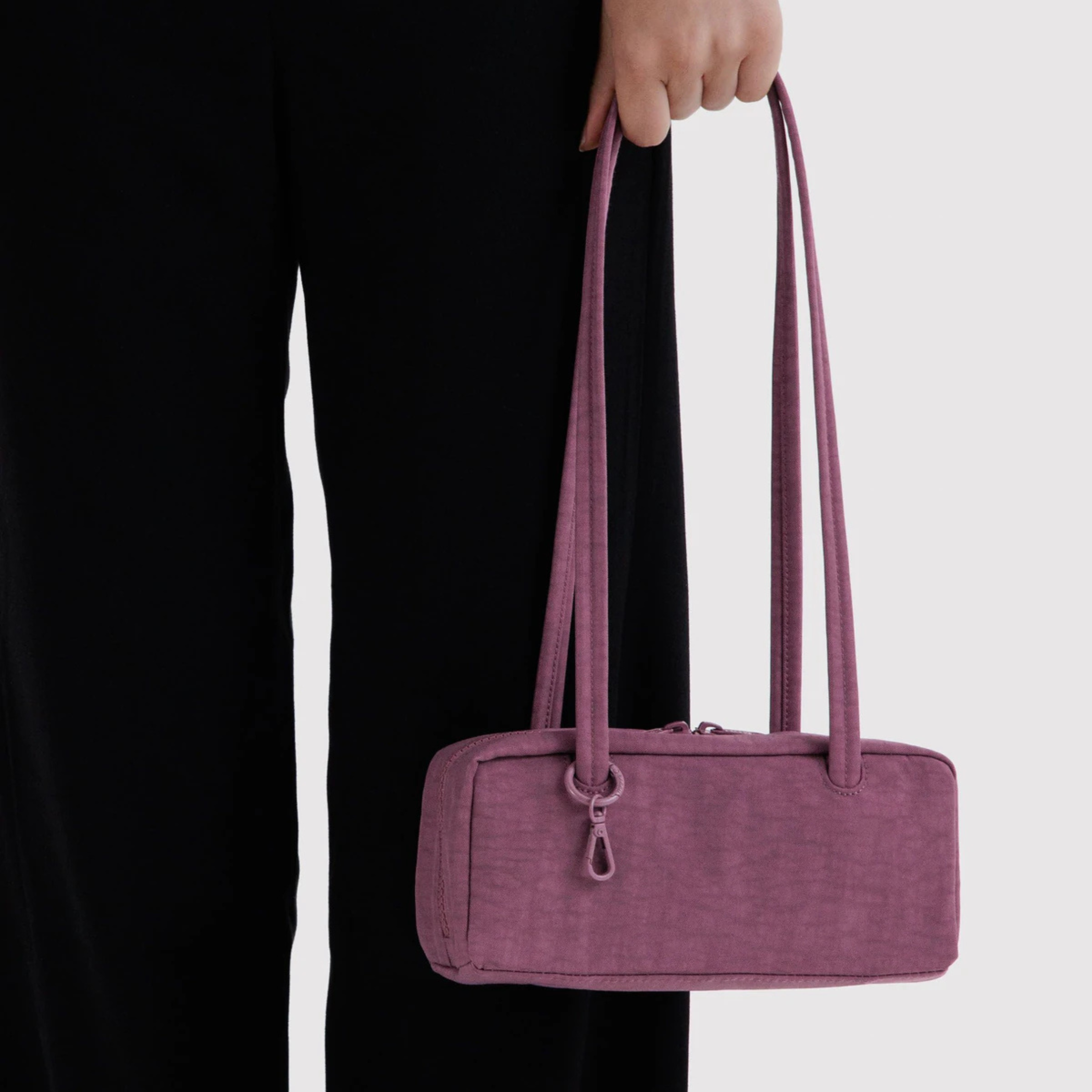 A purple nylon shoulder bag.