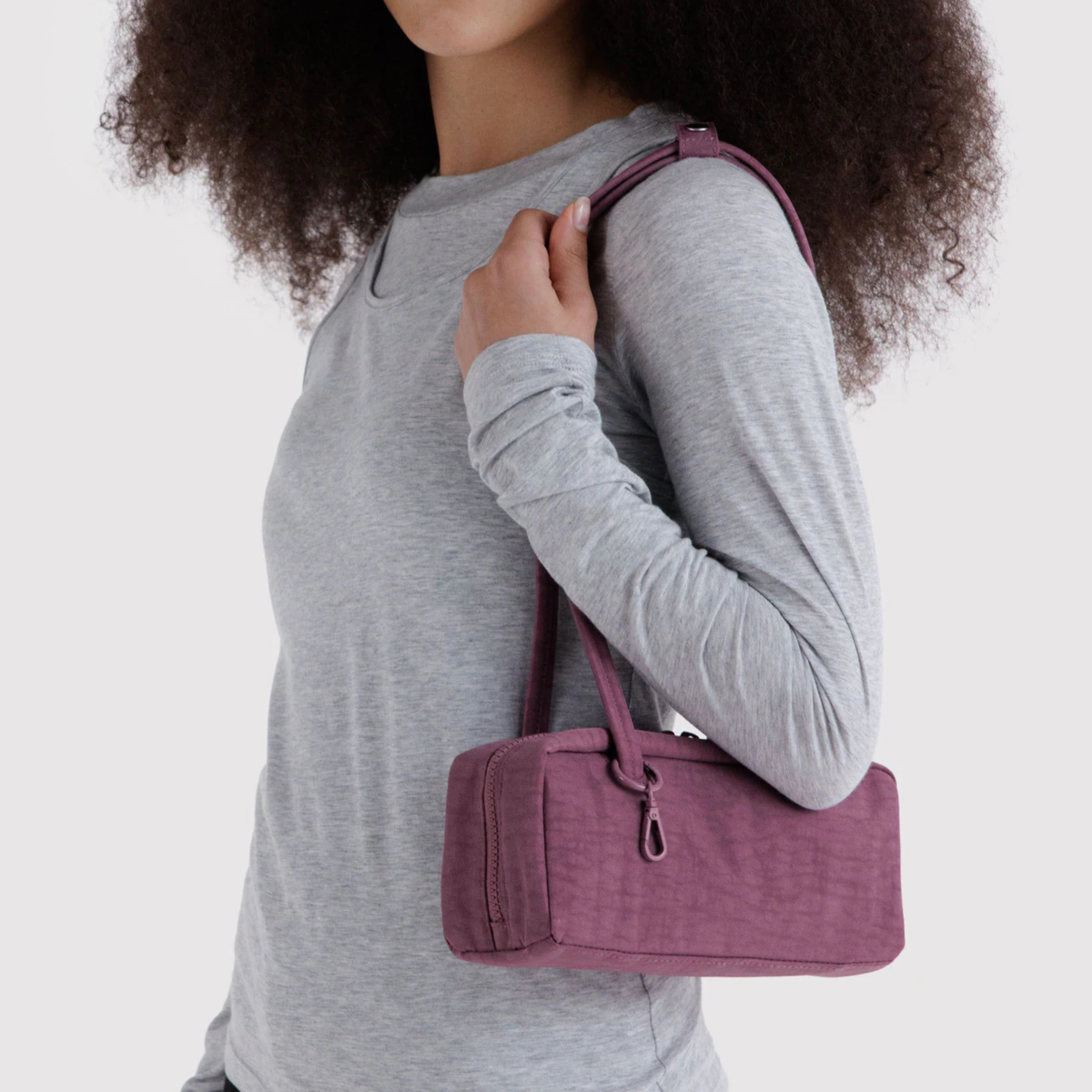 A purple nylon shoulder bag.