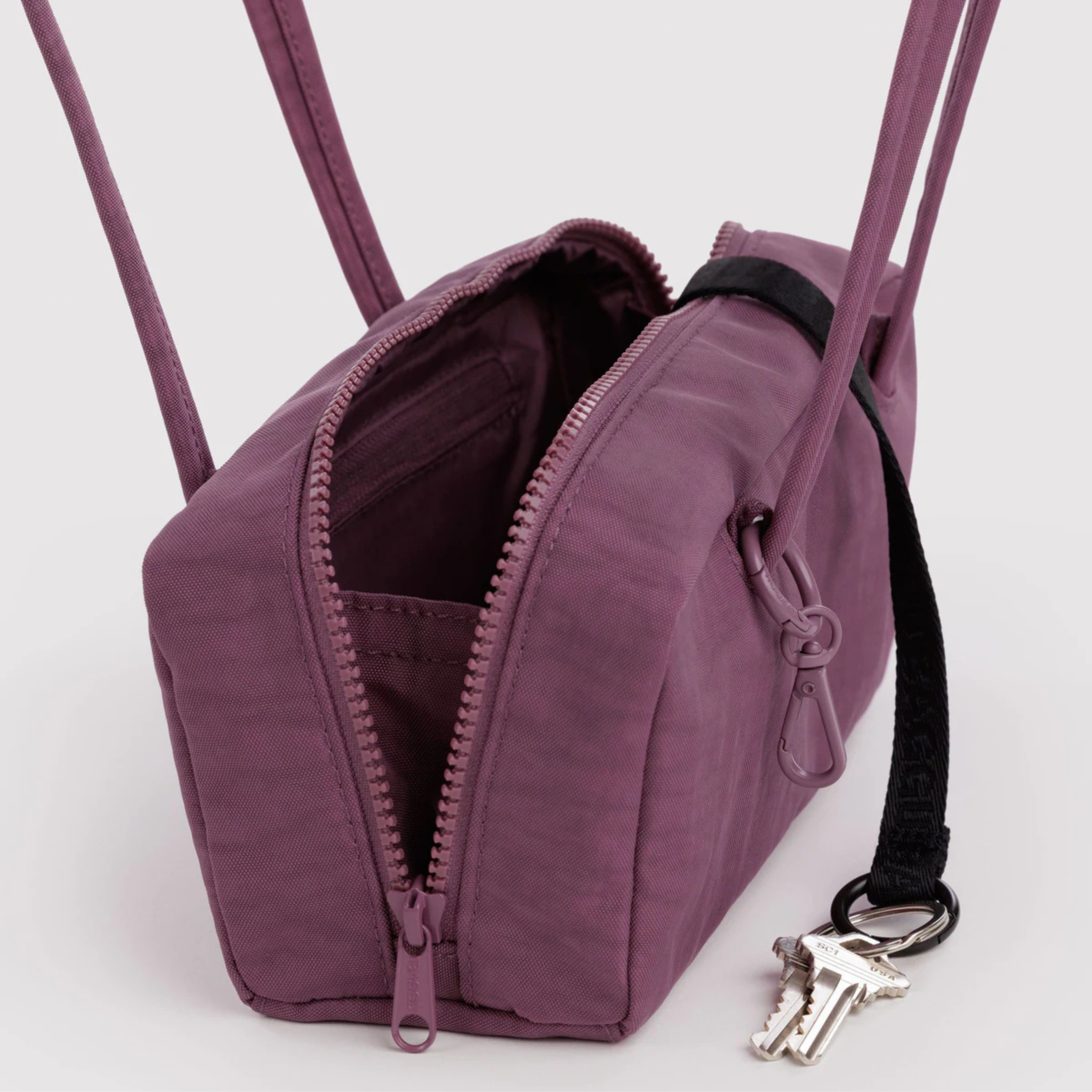 A purple nylon shoulder bag.