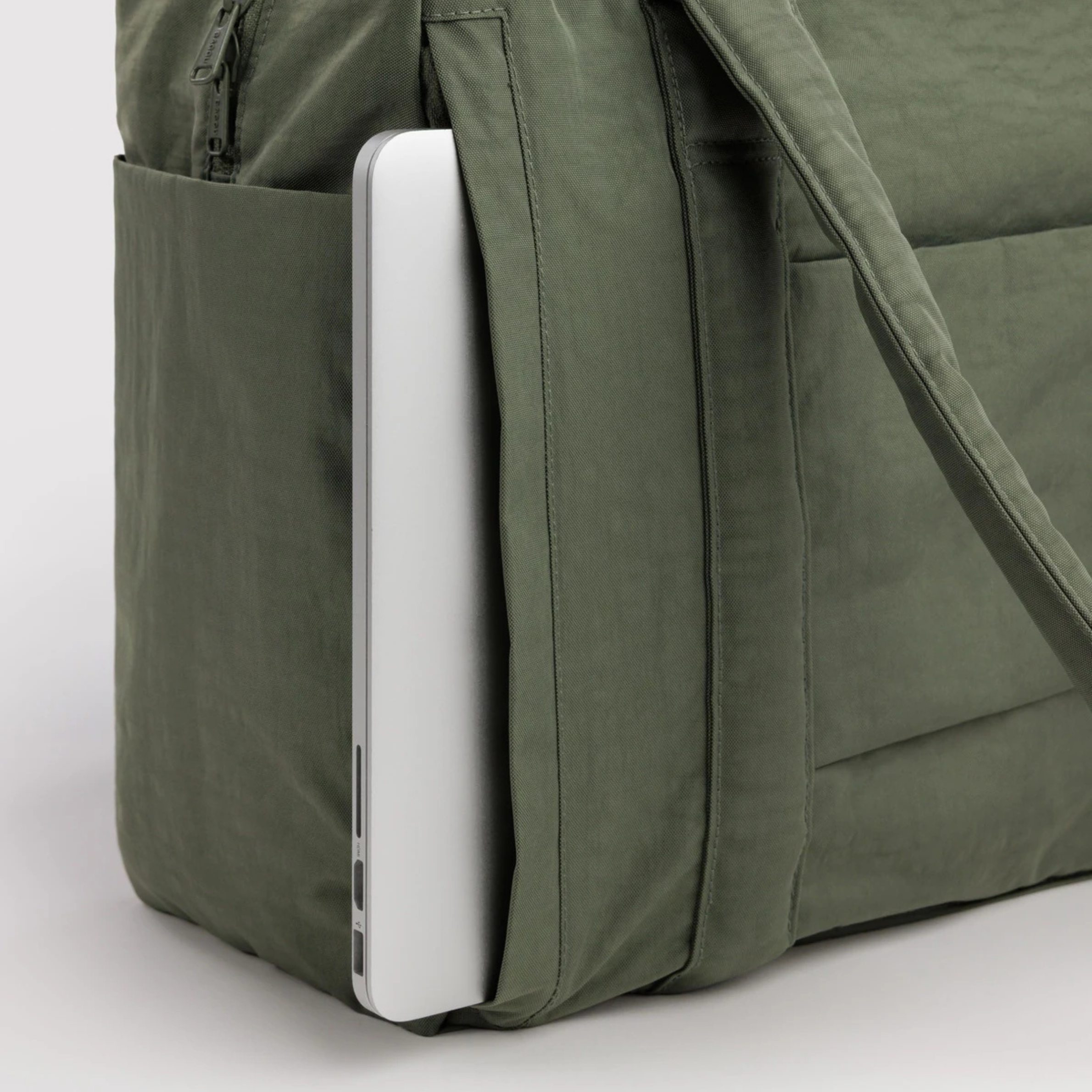 A green nylon small carry on bag.