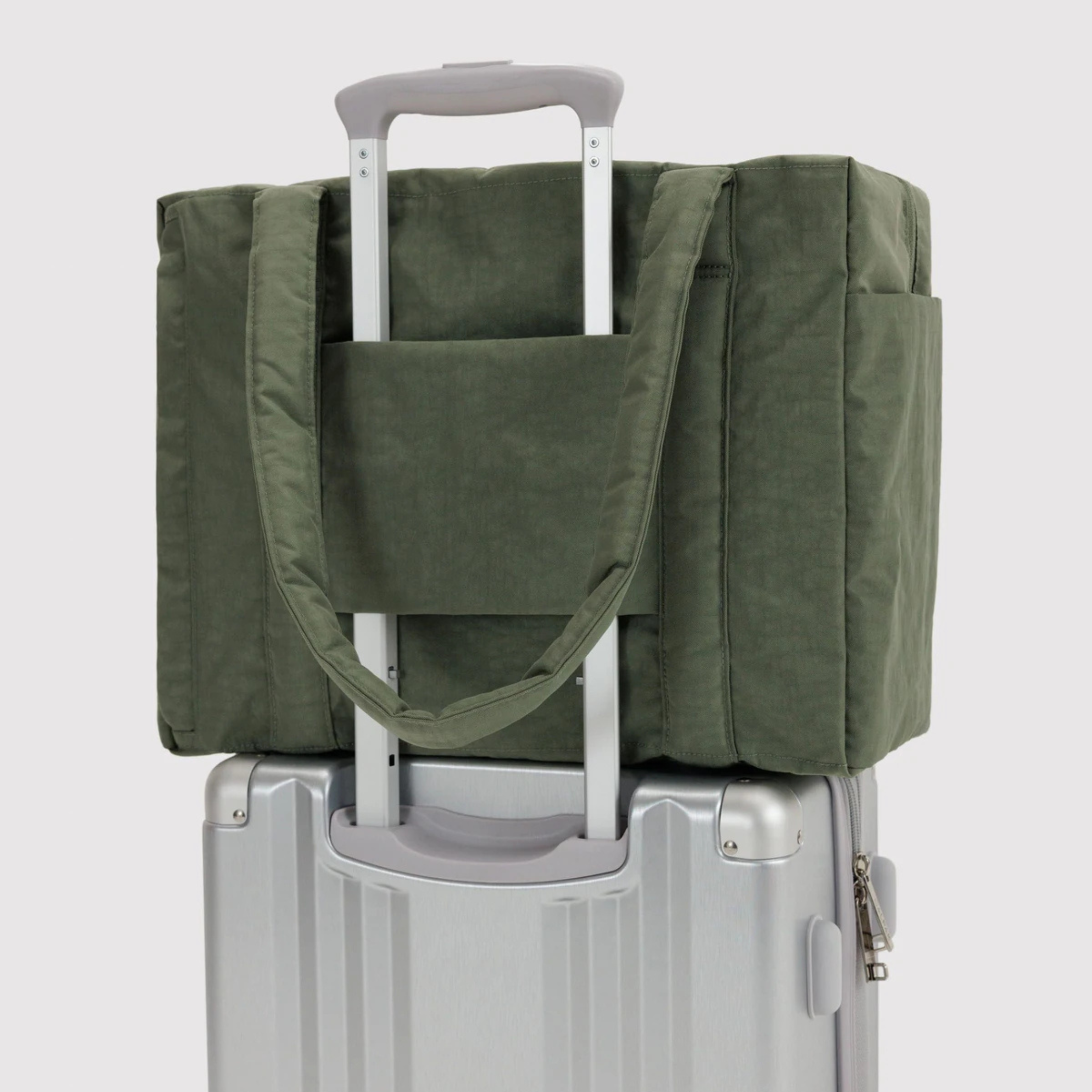 A green nylon small carry on bag.