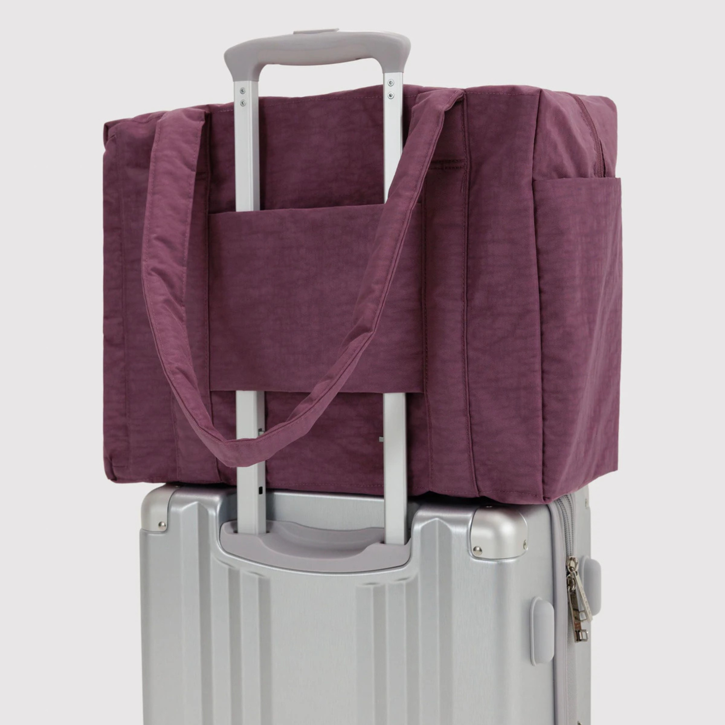 A purple nylon carry on bag.