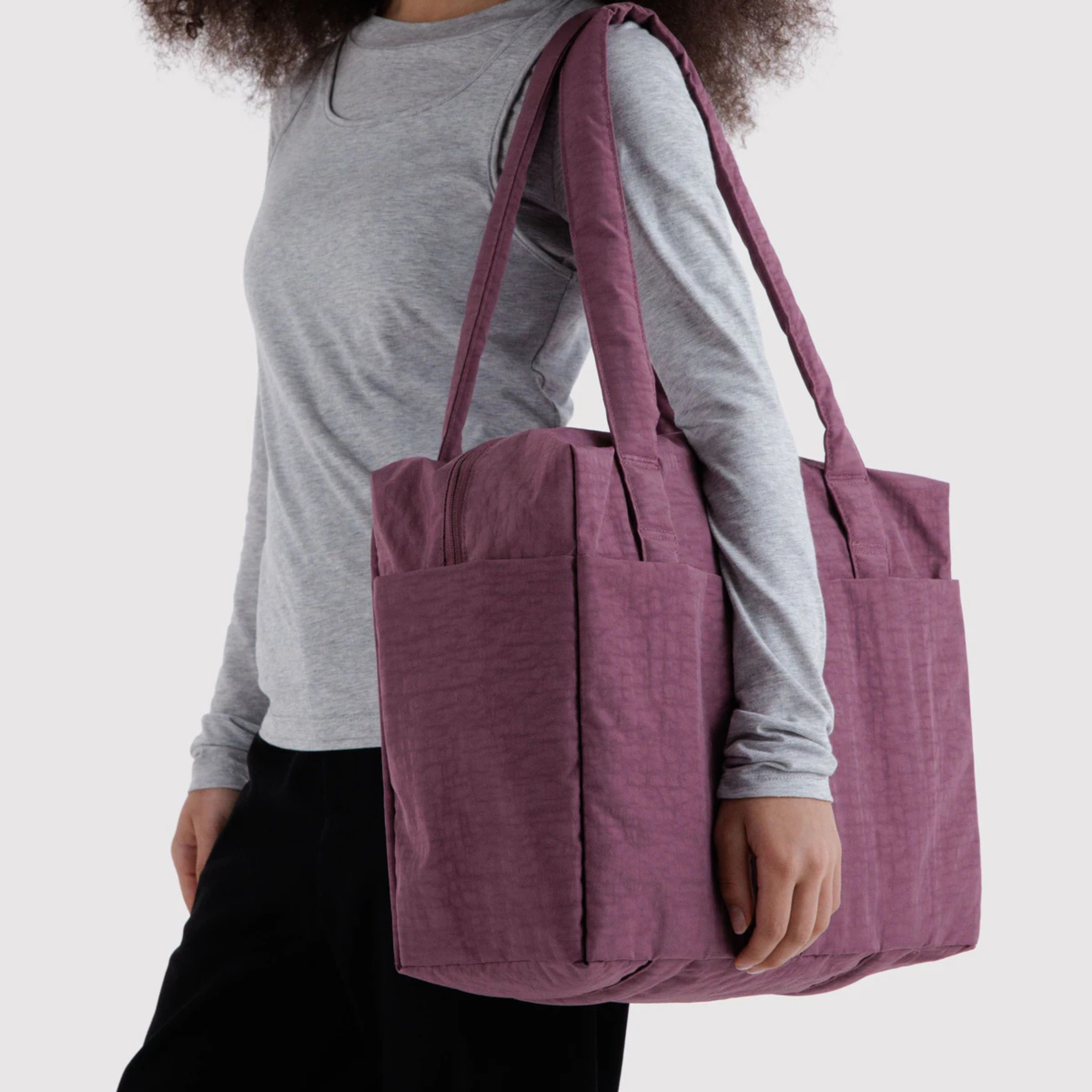 A purple nylon carry on bag.