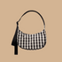 A black and cream gingham crescent bag.
