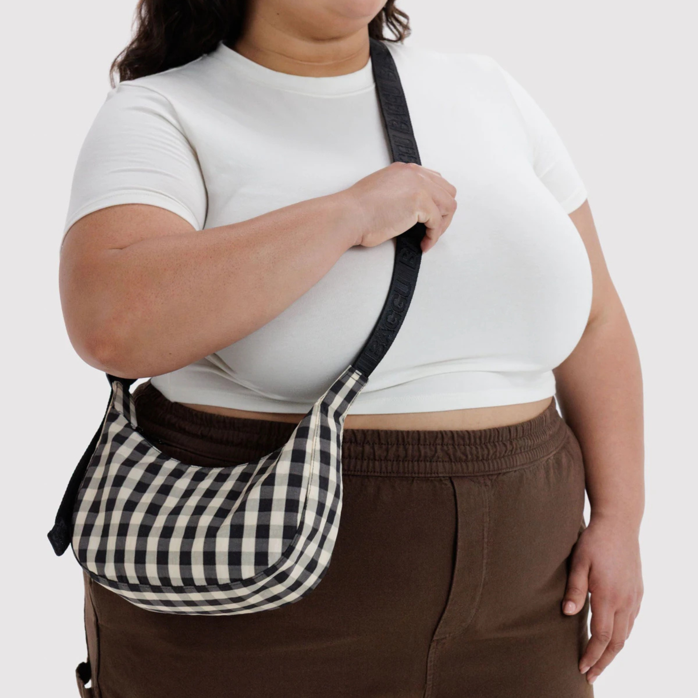 A black and cream gingham crescent bag.