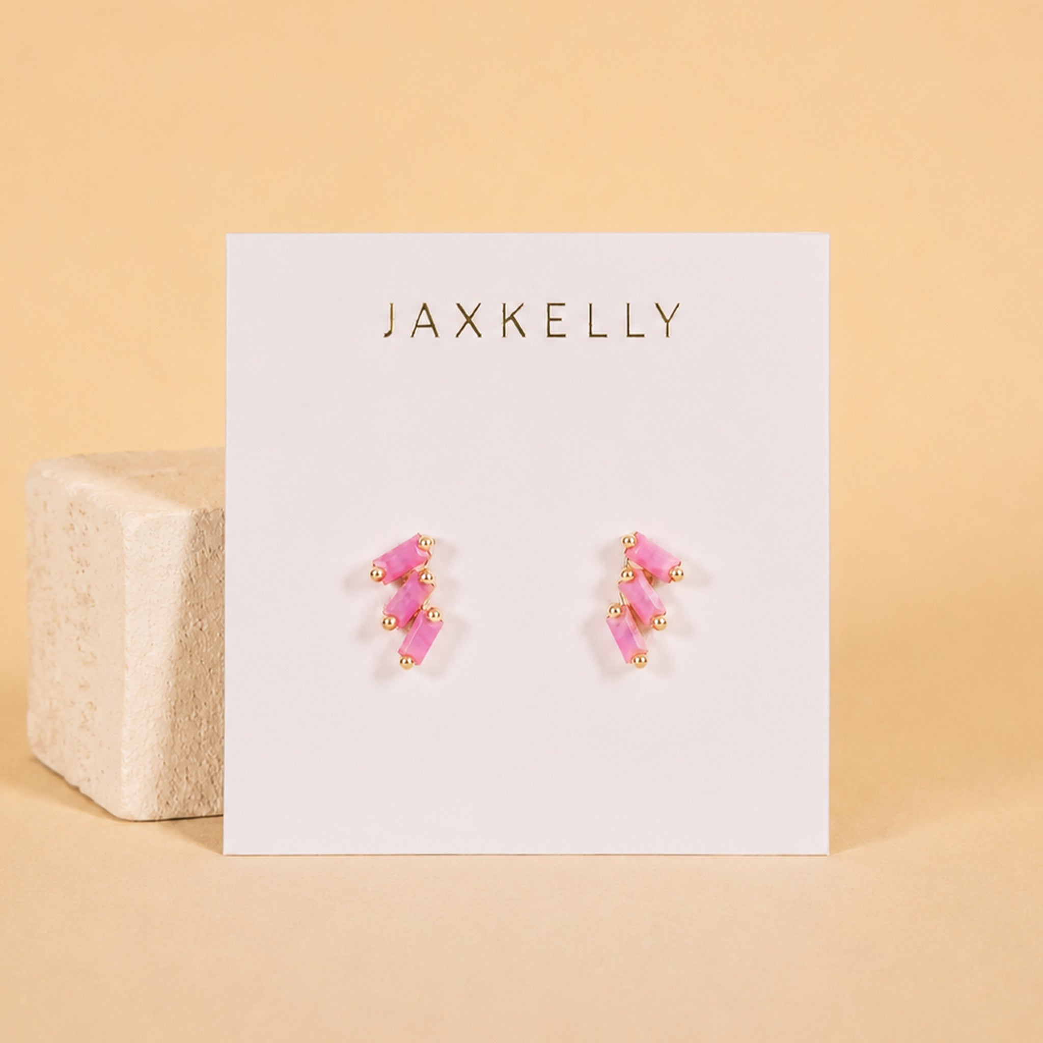 A pink offset trio stud earring. 