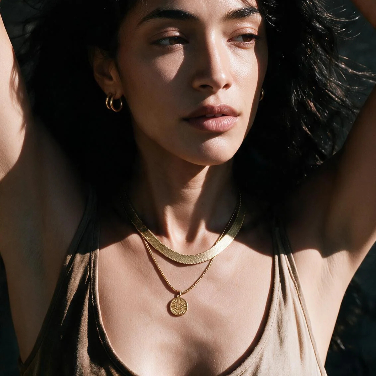 a gold snake chain necklace. 