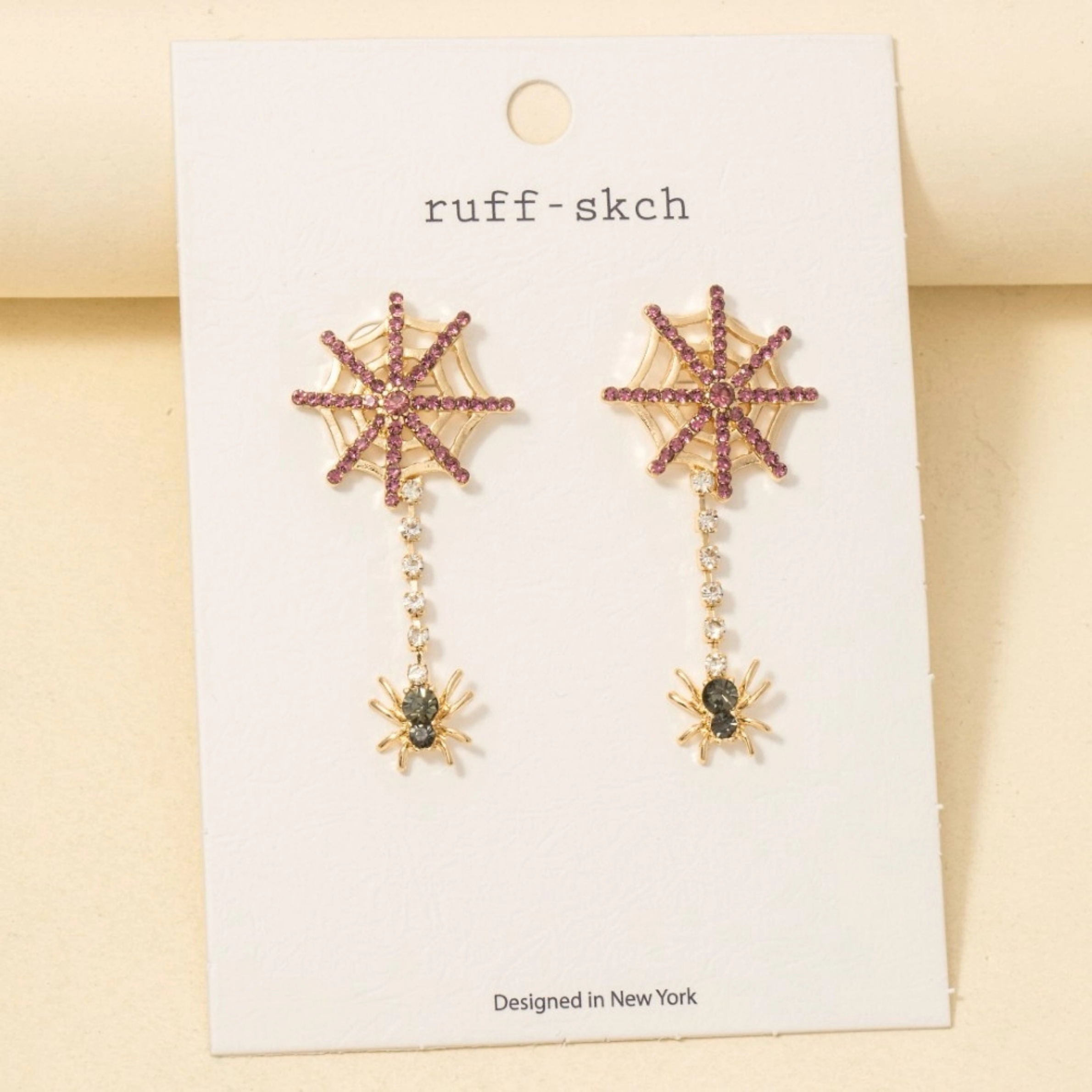 a pair of dangle spider web earrings.