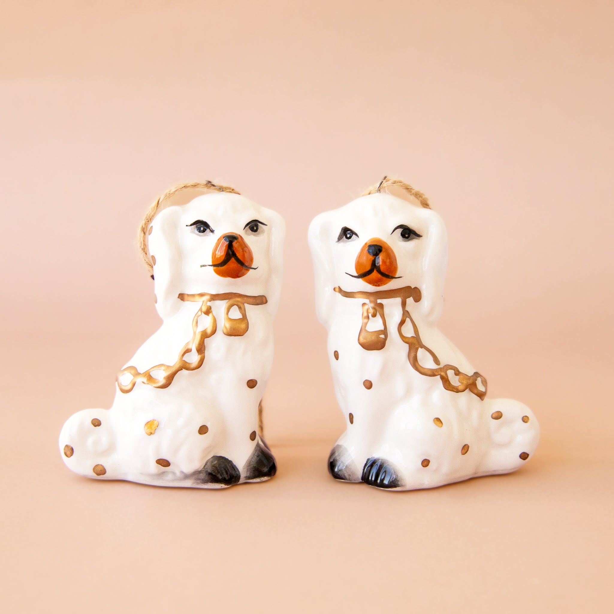 A pair of white dog shaped ornaments. 
